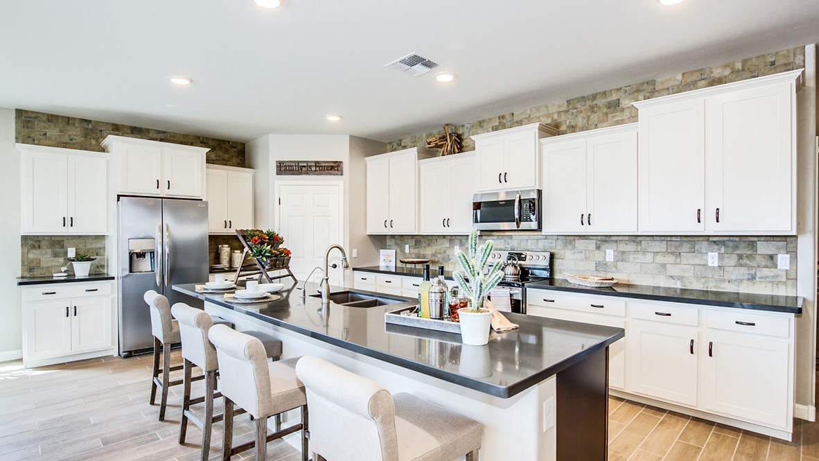 Welcome to The Citrine, a spacious single-story new home located in the Sycamore Vista. With 2,577 square feet of well-planned living space, this home offers four bedrooms, three bathrooms, and a dedicated study, making it ideal for families who value both space and convenience.  As you enter through the inviting covered porch, you’re greeted by a bright and airy entryway that flows into the heart of the home. The expansive great room, dining area, and kitchen are thoughtfully connected, creating an ideal space for entertaining or enjoying time with family. The kitchen features a large island, quartz countertops, and Shaker-style cabinetry. A spacious pantry and modern stainless-steel appliances ensure your kitchen is both functional and stylish.  The Citrine’s layout includes a generously sized primary bedroom, carefully positioned for privacy at the rear of the home. This room features a large walk-in closet and an en-suite bathroom with luxurious super shower. The additional three bedrooms are well-sized and located in separate areas of the home, ensuring privacy and easy access to two more full bathrooms.  One of the highlights of The Citrine is its versatile study, which can be used as a home office, media room, or extra bedroom for guests. The large laundry room, conveniently situated near the bedrooms, adds to the home’s practicality.  The covered patio, accessible from the great room, offers a perfect spot for outdoor living, where you can enjoy Arizona’s beautiful weather throughout the year. Whether you’re hosting a barbecue or simply relaxing, this outdoor space enhances the home’s appeal.  Designed with energy efficiency and modern living in mind, The Citrine includes smart home technology ensuring comfort and sustainability. Large windows throughout the home allow natural light to brighten every corner.  The Citrine combines style, comfort, and practicality, making it a perfect place to call home in one of Vails’s most sought-after communities.