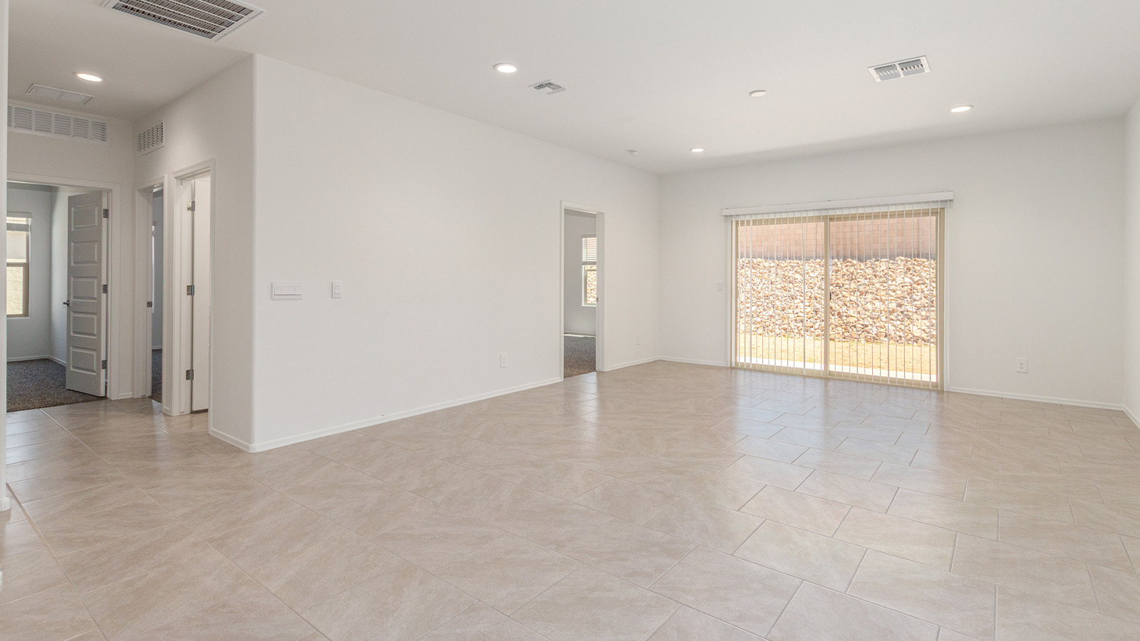 Step into The Elgin, a spacious single-story home located in the scenic Sycamore Vista community in Vail, AZ. This floor plan offers 1,635 square feet of well-planned living space, perfect for those who appreciate both comfort and functionality. With four bedrooms, two bathrooms, and a 3-car garage, The Elgin provides the ideal setting for modern living amidst the beauty of the Santa Rita Mountains.  As you enter through the inviting front porch, you’re welcomed by an open and airy floor plan that flows effortlessly from one room to the next. The heart of the home is the expansive great room, seamlessly connected to the dining area and kitchen, making it ideal for everyday living and entertaining. The kitchen is a chef’s delight, featuring a large island with a breakfast bar, granite countertops, and Shaker-style cabinetry, offering ample storage and workspace. The walk-in pantry and adjacent utility room add convenience and organization to your culinary adventures.  The primary suite is designed with relaxation in mind, offering a spacious bedroom with a walk-in closet and a private en-suite bathroom. This personal haven is positioned at the rear of the home for added privacy. The three additional bedrooms are located towards the front of the home, providing flexibility for guests, family, or a home office setup. A second full bathroom is conveniently situated near these bedrooms.  One of the standout features of The Elgin is the 3-car garage, providing plenty of room for vehicles, storage, or even a workshop. Whether you have multiple cars, recreational vehicles, or just need extra space, this garage has you covered.  Step outside to enjoy your covered patio, which is perfect for outdoor dining, lounging, or simply taking in the stunning Arizona sunsets. The large backyard provides endless possibilities for gardening, play, or creating your own outdoor oasis.  Living at Sycamore Vista means enjoying a community that balances modern amenities with natural beauty. Your home includes luxury finishes such as staggered wood-look ceramic tile flooring throughout most areas, granite countertops, and energy-efficient features like spray foam insulation and tankless water heaters. Additionally, each home in the community comes equipped with a Home is Connected® Smart Home package, offering conveniences like a smart thermostat, video doorbell, keyless entry, a wifi-enabled garage door opener and more.  Sycamore Vista’s prime location in the Vail School District makes it a great choice for families. With schools like Sycamore Elementary and Corona Foothills Middle School nearby, you’ll have peace of mind knowing your children are receiving a quality education. The community’s higher elevation offers cooler summer temperatures and spectacular night skies, making it a perfect spot for stargazing.  Experience the perfect blend of rural charm and modern convenience at Sycamore Vista, where The Elgin offers a space that’s more than just a house—it’s a home designed to grow with you and your family.  *Images shown are for reference only. They depict The Elgin spec home and may not represent the actual home.
