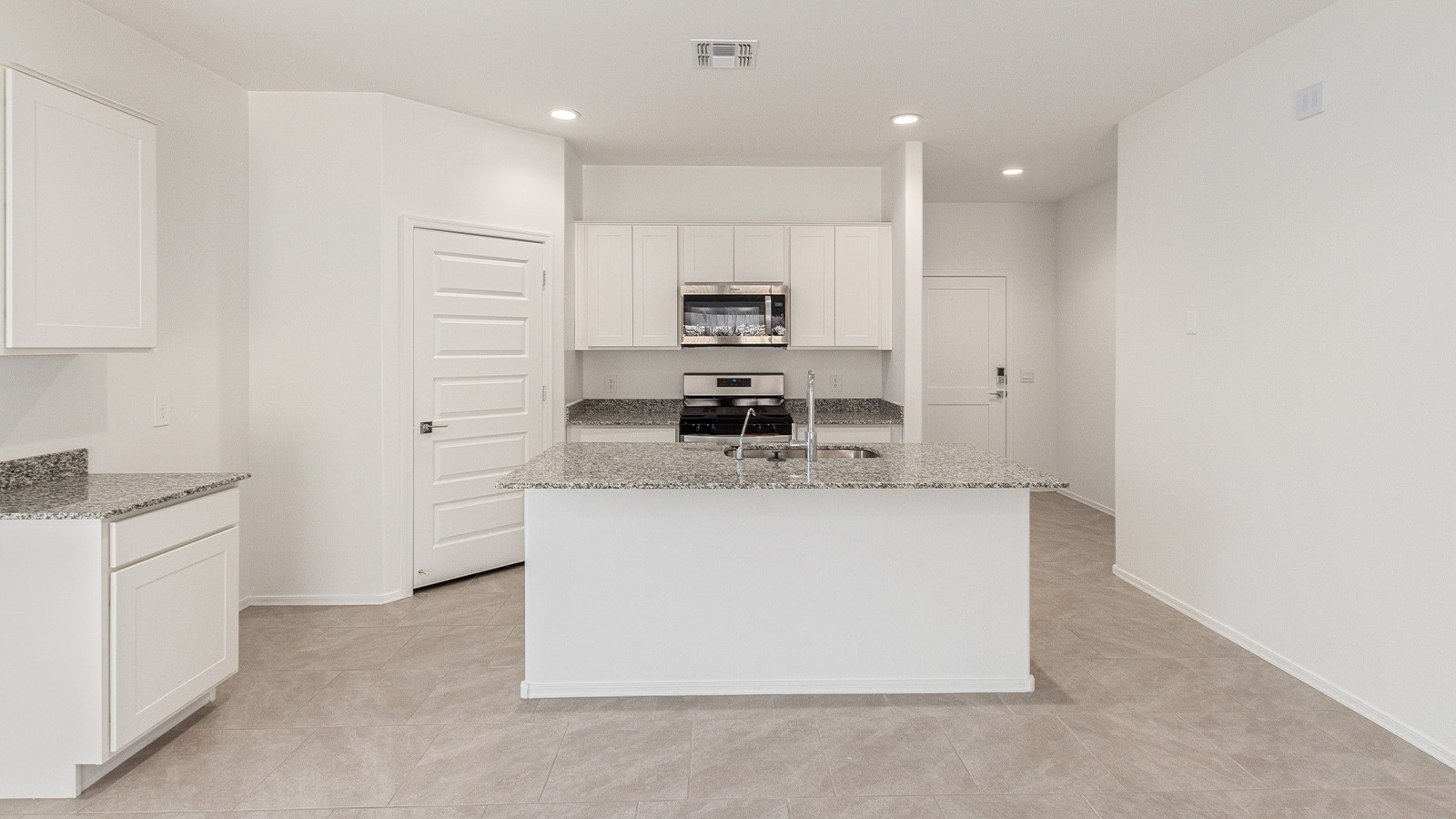 Step into The Elgin, a spacious single-story home located in the scenic Sycamore Vista community in Vail, AZ. This floor plan offers 1,635 square feet of well-planned living space, perfect for those who appreciate both comfort and functionality. With four bedrooms, two bathrooms, and a 3-car garage, The Elgin provides the ideal setting for modern living amidst the beauty of the Santa Rita Mountains.  As you enter through the inviting front porch, you’re welcomed by an open and airy floor plan that flows effortlessly from one room to the next. The heart of the home is the expansive great room, seamlessly connected to the dining area and kitchen, making it ideal for everyday living and entertaining. The kitchen is a chef’s delight, featuring a large island with a breakfast bar, granite countertops, and Shaker-style cabinetry, offering ample storage and workspace. The walk-in pantry and adjacent utility room add convenience and organization to your culinary adventures.  The primary suite is designed with relaxation in mind, offering a spacious bedroom with a walk-in closet and a private en-suite bathroom. This personal haven is positioned at the rear of the home for added privacy. The three additional bedrooms are located towards the front of the home, providing flexibility for guests, family, or a home office setup. A second full bathroom is conveniently situated near these bedrooms.  One of the standout features of The Elgin is the 3-car garage, providing plenty of room for vehicles, storage, or even a workshop. Whether you have multiple cars, recreational vehicles, or just need extra space, this garage has you covered.  Step outside to enjoy your covered patio, which is perfect for outdoor dining, lounging, or simply taking in the stunning Arizona sunsets. The large backyard provides endless possibilities for gardening, play, or creating your own outdoor oasis.  Living at Sycamore Vista means enjoying a community that balances modern amenities with natural beauty. Your home includes luxury finishes such as staggered wood-look ceramic tile flooring throughout most areas, granite countertops, and energy-efficient features like spray foam insulation and tankless water heaters. Additionally, each home in the community comes equipped with a Home is Connected® Smart Home package, offering conveniences like a smart thermostat, video doorbell, keyless entry, a wifi-enabled garage door opener and more.  Sycamore Vista’s prime location in the Vail School District makes it a great choice for families. With schools like Sycamore Elementary and Corona Foothills Middle School nearby, you’ll have peace of mind knowing your children are receiving a quality education. The community’s higher elevation offers cooler summer temperatures and spectacular night skies, making it a perfect spot for stargazing.  Experience the perfect blend of rural charm and modern convenience at Sycamore Vista, where The Elgin offers a space that’s more than just a house—it’s a home designed to grow with you and your family.  *Images shown are for reference only. They depict The Elgin spec home and may not represent the actual home.