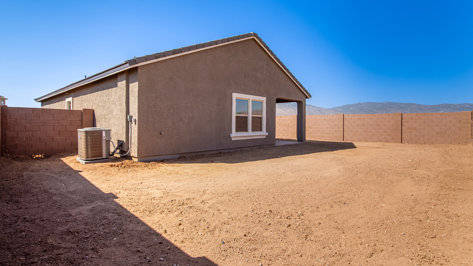 Snuggled within the serene surroundings of Sycamore Vista, The Baxter offers a blend of comfort and convenience, making it a perfect fit for modern living. Spanning 1,423 square feet, this thoughtfully crafted single-story home features three bedrooms, two bathrooms, and a three-car garage, all within the picturesque foothills of the Santa Rita Mountains.  As you step onto the welcoming front porch and enter through the foyer, you’re greeted by a spacious and open floor plan that flows effortlessly into the heart of the home. The great room is designed for both relaxation and socializing, seamlessly connecting to the dining area and kitchen. The kitchen is a culinary enthusiast's dream, featuring sleek granite countertops, a central island, and Shaker-style cabinetry, all designed to offer ample storage and a stylish backdrop for your cooking adventures. The adjacent pantry ensures that all your essentials are within easy reach, making meal prep both efficient and enjoyable.  The primary bedroom, located at the rear of the home for enhanced privacy, serves as a peaceful retreat. It includes a spacious walk-in closet and an en-suite bathroom equipped with dual vanities and a luxurious shower. The two additional bedrooms are thoughtfully positioned near the front of the home, sharing a full bathroom, making it ideal for families or guests.  Outdoor living is a key feature of The Baxter, with a covered patio that extends from the dining area, offering the perfect space to enjoy Tucson’s stunning sunsets or host a weekend barbecue. The three-car garage provides ample space for vehicles, storage, or even a small workshop, catering to various needs.  Living in Sycamore Vista means you’re part of a community that values both convenience and quality of life. Each home in this community comes with beautifully landscaped front yards, equipped with auto drip irrigation systems and soft water loops, enhancing the beauty and functionality of your outdoor space. Additionally, Sycamore Vista homes are energy-efficient, featuring DOE Zero Energy Ready standards, including spray foam insulation, tankless water heaters, and LED lighting throughout, ensuring lower energy costs and a reduced environmental footprint.  The community’s higher elevation not only offers cooler summer temperatures but also less light pollution, making it a perfect spot for stargazing. Sycamore Vista is ideally located near top-rated schools in the Vail School District, including Sycamore Elementary and Corona Foothills Middle School, making it an ideal choice for families.  Beyond the tranquility of home, outdoor enthusiasts will appreciate the proximity to local state and national parks, including Coronado National Forest and Colossal Cave Mountain Park, offering endless opportunities for hiking, biking, and exploring Arizona’s natural beauty. The community’s location also provides easy access to shopping, dining, and major employers like the Target Distribution Center and the Amazon Fulfillment Center, ensuring that everything you need is within reach.  Experience the best of Arizona living at Sycamore Vista, where The Baxter offers the perfect blend of modern amenities, quality craftsmanship, and the natural beauty of the Santa Rita Mountains, creating a place you’ll be proud to call home.