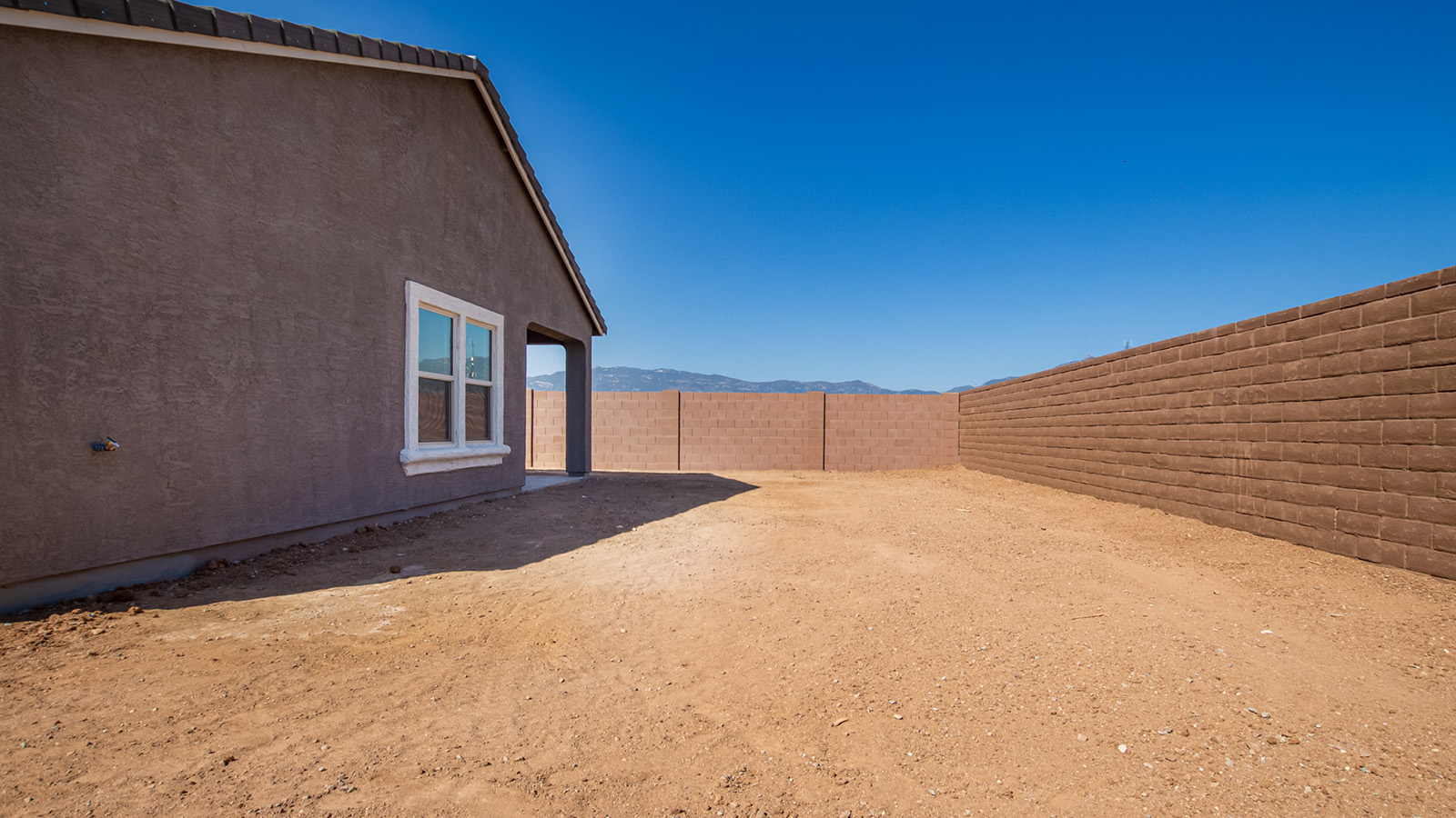 Snuggled within the serene surroundings of Sycamore Vista, The Baxter offers a blend of comfort and convenience. Spanning 1,423 square feet, this thoughtfully crafted single-story home features three bedrooms, two bathrooms, and a two-car garage.  As you step into the welcoming front porch, you’re greeted by a spacious and open floor plan that flows effortlessly into the heart of the home. The great room is designed for both relaxation and socializing, seamlessly connecting to the dining area and kitchen. The kitchen is a culinary enthusiast's dream, featuring quartz countertops, a central island, and Shaker-style cabinetry, all designed to offer ample storage and a style. The adjacent pantry ensures that all your essentials are within easy reach, making meal prep both efficient and enjoyable.  The primary bedroom is located at the rear of the home for enhanced privacy. It includes a spacious walk-in closet and an en-suite bathroom. The two additional bedrooms are thoughtfully positioned near the front of the home, sharing a full bathroom, making it ideal for families or guests.  Outdoor living is a key feature of The Baxter, with a covered patio that extends from the dining area, offering the perfect space to enjoy Tucson’s stunning sunsets or host a weekend barbecue.  Living in Sycamore Vista means you’re part of a community that values both convenience and quality of life. Each home in this community comes with beautifully landscaped front yards, equipped with auto drip irrigation systems. Additionally, Sycamore Vista homes are energy-efficient, featuring DOE Zero Energy Ready standards, including spray foam insulation, tankless water heaters, and LED lighting throughout, ensuring lower energy costs and a reduced environmental footprint.  Experience the best of Arizona living at Sycamore Vista, where The Baxter offers the perfect blend of modern amenities, quality, and craftsmanship.