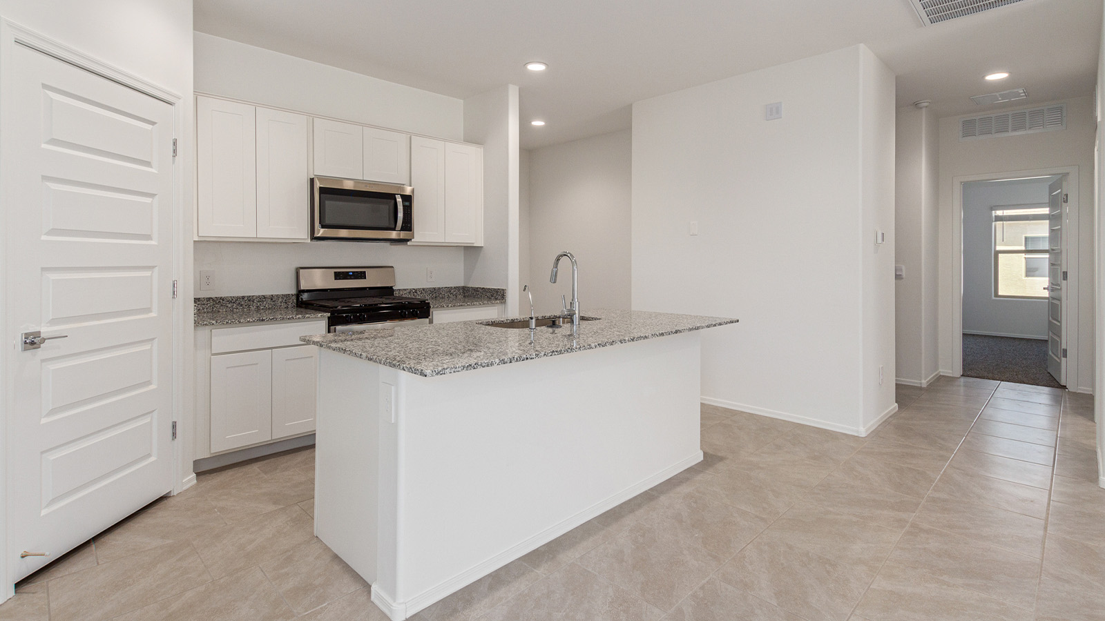 Step into The Elgin, a spacious single-story home located in the scenic Sycamore Vista community in Vail, AZ. This floor plan offers 1,635 square feet of well-planned living space, perfect for those who appreciate both comfort and functionality. With four bedrooms, two bathrooms, and a 3-car garage, The Elgin provides the ideal setting for modern living amidst the beauty of the Santa Rita Mountains.  As you enter through the inviting front porch, you’re welcomed by an open and airy floor plan that flows effortlessly from one room to the next. The heart of the home is the expansive great room, seamlessly connected to the dining area and kitchen, making it ideal for everyday living and entertaining. The kitchen is a chef’s delight, featuring a large island with a breakfast bar, granite countertops, and Shaker-style cabinetry, offering ample storage and workspace. The walk-in pantry and adjacent utility room add convenience and organization to your culinary adventures.  The primary suite is designed with relaxation in mind, offering a spacious bedroom with a walk-in closet and a private en-suite bathroom. This personal haven is positioned at the rear of the home for added privacy. The three additional bedrooms are located towards the front of the home, providing flexibility for guests, family, or a home office setup. A second full bathroom is conveniently situated near these bedrooms.  One of the standout features of The Elgin is the 3-car garage, providing plenty of room for vehicles, storage, or even a workshop. Whether you have multiple cars, recreational vehicles, or just need extra space, this garage has you covered.  Step outside to enjoy your covered patio, which is perfect for outdoor dining, lounging, or simply taking in the stunning Arizona sunsets. The large backyard provides endless possibilities for gardening, play, or creating your own outdoor oasis.  Living at Sycamore Vista means enjoying a community that balances modern amenities with natural beauty. Your home includes luxury finishes such as staggered wood-look ceramic tile flooring throughout most areas, granite countertops, and energy-efficient features like spray foam insulation and tankless water heaters. Additionally, each home in the community comes equipped with a Home is Connected® Smart Home package, offering conveniences like a smart thermostat, video doorbell, keyless entry, a wifi-enabled garage door opener and more.  Sycamore Vista’s prime location in the Vail School District makes it a great choice for families. With schools like Sycamore Elementary and Corona Foothills Middle School nearby, you’ll have peace of mind knowing your children are receiving a quality education. The community’s higher elevation offers cooler summer temperatures and spectacular night skies, making it a perfect spot for stargazing.  Experience the perfect blend of rural charm and modern convenience at Sycamore Vista, where The Elgin offers a space that’s more than just a house—it’s a home designed to grow with you and your family.  *Images shown are for reference only. They depict the Elgin model home and may not represent the actual home.