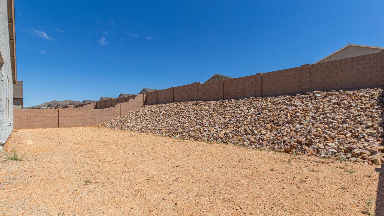 Step into The Elgin, a spacious single-story home located in the scenic Sycamore Vista community in Vail, AZ. This floor plan offers 1,635 square feet of well-planned living space, perfect for those who appreciate both comfort and functionality. With four bedrooms, two bathrooms, and a 3-car garage, The Elgin provides the ideal setting for modern living amidst the beauty of the Santa Rita Mountains.  As you enter through the inviting front porch, you’re welcomed by an open and airy floor plan that flows effortlessly from one room to the next. The heart of the home is the expansive great room, seamlessly connected to the dining area and kitchen, making it ideal for everyday living and entertaining. The kitchen is a chef’s delight, featuring a large island with a breakfast bar, granite countertops, and Shaker-style cabinetry, offering ample storage and workspace. The walk-in pantry and adjacent utility room add convenience and organization to your culinary adventures.  The primary suite is designed with relaxation in mind, offering a spacious bedroom with a walk-in closet and a private en-suite bathroom. This personal haven is positioned at the rear of the home for added privacy. The three additional bedrooms are located towards the front of the home, providing flexibility for guests, family, or a home office setup. A second full bathroom is conveniently situated near these bedrooms.  One of the standout features of The Elgin is the 3-car garage, providing plenty of room for vehicles, storage, or even a workshop. Whether you have multiple cars, recreational vehicles, or just need extra space, this garage has you covered.  Step outside to enjoy your covered patio, which is perfect for outdoor dining, lounging, or simply taking in the stunning Arizona sunsets. The large backyard provides endless possibilities for gardening, play, or creating your own outdoor oasis.  Living at Sycamore Vista means enjoying a community that balances modern amenities with natural beauty. Your home includes luxury finishes such as staggered wood-look ceramic tile flooring throughout most areas, granite countertops, and energy-efficient features like spray foam insulation and tankless water heaters. Additionally, each home in the community comes equipped with a Home is Connected® Smart Home package, offering conveniences like a smart thermostat, video doorbell, keyless entry, a wifi-enabled garage door opener and more.  Sycamore Vista’s prime location in the Vail School District makes it a great choice for families. With schools like Sycamore Elementary and Corona Foothills Middle School nearby, you’ll have peace of mind knowing your children are receiving a quality education. The community’s higher elevation offers cooler summer temperatures and spectacular night skies, making it a perfect spot for stargazing.  Experience the perfect blend of rural charm and modern convenience at Sycamore Vista, where The Elgin offers a space that’s more than just a house—it’s a home designed to grow with you and your family.  *Images shown are for reference only. They depict the Elgin model home and may not represent the actual home.