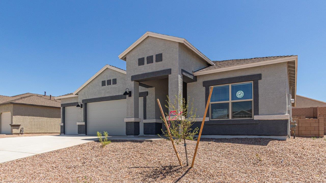 Step into The Elgin, a spacious single-story home located in the scenic Sycamore Vista community in Vail, AZ. This floor plan offers 1,635 square feet of well-planned living space, perfect for those who appreciate both comfort and functionality. With four bedrooms, two bathrooms, and a 3-car garage, The Elgin provides the ideal setting for modern living amidst the beauty of the Santa Rita Mountains.  As you enter through the inviting front porch, you’re welcomed by an open and airy floor plan that flows effortlessly from one room to the next. The heart of the home is the expansive great room, seamlessly connected to the dining area and kitchen, making it ideal for everyday living and entertaining. The kitchen is a chef’s delight, featuring a large island with a breakfast bar, granite countertops, and Shaker-style cabinetry, offering ample storage and workspace. The walk-in pantry and adjacent utility room add convenience and organization to your culinary adventures.  The primary suite is designed with relaxation in mind, offering a spacious bedroom with a walk-in closet and a private en-suite bathroom. This personal haven is positioned at the rear of the home for added privacy. The three additional bedrooms are located towards the front of the home, providing flexibility for guests, family, or a home office setup. A second full bathroom is conveniently situated near these bedrooms.  One of the standout features of The Elgin is the 3-car garage, providing plenty of room for vehicles, storage, or even a workshop. Whether you have multiple cars, recreational vehicles, or just need extra space, this garage has you covered.  Step outside to enjoy your covered patio, which is perfect for outdoor dining, lounging, or simply taking in the stunning Arizona sunsets. The large backyard provides endless possibilities for gardening, play, or creating your own outdoor oasis.  Living at Sycamore Vista means enjoying a community that balances modern amenities with natural beauty. Your home includes luxury finishes such as staggered wood-look ceramic tile flooring throughout most areas, granite countertops, and energy-efficient features like spray foam insulation and tankless water heaters. Additionally, each home in the community comes equipped with a Home is Connected® Smart Home package, offering conveniences like a smart thermostat, video doorbell, keyless entry, a wifi-enabled garage door opener and more.  Sycamore Vista’s prime location in the Vail School District makes it a great choice for families. With schools like Sycamore Elementary and Corona Foothills Middle School nearby, you’ll have peace of mind knowing your children are receiving a quality education. The community’s higher elevation offers cooler summer temperatures and spectacular night skies, making it a perfect spot for stargazing.  Experience the perfect blend of rural charm and modern convenience at Sycamore Vista, where The Elgin offers a space that’s more than just a house—it’s a home designed to grow with you and your family.