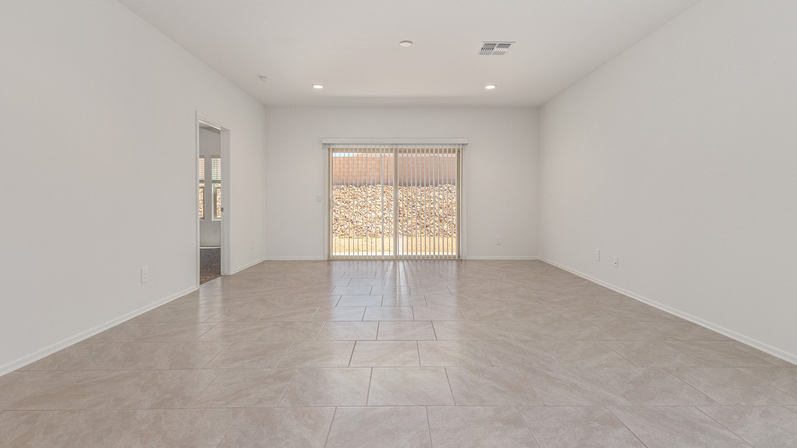 Step into The Elgin, a spacious single-story home located in the scenic Sycamore Vista community in Vail, AZ. This floor plan offers 1,635 square feet of well-planned living space, perfect for those who appreciate both comfort and functionality. With four bedrooms, two bathrooms, and a 3-car garage, The Elgin provides the ideal setting for modern living amidst the beauty of the Santa Rita Mountains.  As you enter through the inviting front porch, you’re welcomed by an open and airy floor plan that flows effortlessly from one room to the next. The heart of the home is the expansive great room, seamlessly connected to the dining area and kitchen, making it ideal for everyday living and entertaining. The kitchen is a chef’s delight, featuring a large island with a breakfast bar, granite countertops, and Shaker-style cabinetry, offering ample storage and workspace. The walk-in pantry and adjacent utility room add convenience and organization to your culinary adventures.  The primary suite is designed with relaxation in mind, offering a spacious bedroom with a walk-in closet and a private en-suite bathroom. This personal haven is positioned at the rear of the home for added privacy. The three additional bedrooms are located towards the front of the home, providing flexibility for guests, family, or a home office setup. A second full bathroom is conveniently situated near these bedrooms.  One of the standout features of The Elgin is the 3-car garage, providing plenty of room for vehicles, storage, or even a workshop. Whether you have multiple cars, recreational vehicles, or just need extra space, this garage has you covered.  Step outside to enjoy your covered patio, which is perfect for outdoor dining, lounging, or simply taking in the stunning Arizona sunsets. The large backyard provides endless possibilities for gardening, play, or creating your own outdoor oasis.  Living at Sycamore Vista means enjoying a community that balances modern amenities with natural beauty. Your home includes luxury finishes such as staggered wood-look ceramic tile flooring throughout most areas, granite countertops, and energy-efficient features like spray foam insulation and tankless water heaters. Additionally, each home in the community comes equipped with a Home is Connected® Smart Home package, offering conveniences like a smart thermostat, video doorbell, keyless entry, a wifi-enabled garage door opener and more.  Sycamore Vista’s prime location in the Vail School District makes it a great choice for families. With schools like Sycamore Elementary and Corona Foothills Middle School nearby, you’ll have peace of mind knowing your children are receiving a quality education. The community’s higher elevation offers cooler summer temperatures and spectacular night skies, making it a perfect spot for stargazing.  Experience the perfect blend of rural charm and modern convenience at Sycamore Vista, where The Elgin offers a space that’s more than just a house—it’s a home designed to grow with you and your family.