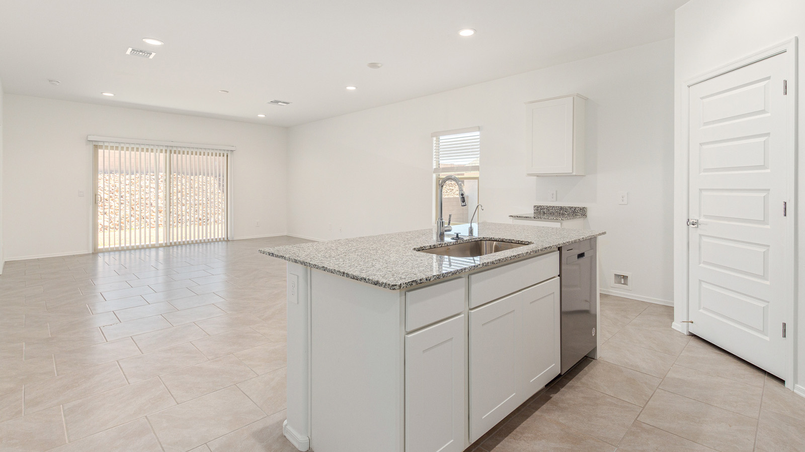 Step into The Elgin, a spacious single-story home located in the scenic Sycamore Vista community in Vail, AZ. This floor plan offers 1,635 square feet of well-planned living space, perfect for those who appreciate both comfort and functionality. With four bedrooms, two bathrooms, and a 3-car garage, The Elgin provides the ideal setting for modern living amidst the beauty of the Santa Rita Mountains.  As you enter through the inviting front porch, you’re welcomed by an open and airy floor plan that flows effortlessly from one room to the next. The heart of the home is the expansive great room, seamlessly connected to the dining area and kitchen, making it ideal for everyday living and entertaining. The kitchen is a chef’s delight, featuring a large island with a breakfast bar, granite countertops, and Shaker-style cabinetry, offering ample storage and workspace. The walk-in pantry and adjacent utility room add convenience and organization to your culinary adventures.  The primary suite is designed with relaxation in mind, offering a spacious bedroom with a walk-in closet and a private en-suite bathroom. This personal haven is positioned at the rear of the home for added privacy. The three additional bedrooms are located towards the front of the home, providing flexibility for guests, family, or a home office setup. A second full bathroom is conveniently situated near these bedrooms.  One of the standout features of The Elgin is the 3-car garage, providing plenty of room for vehicles, storage, or even a workshop. Whether you have multiple cars, recreational vehicles, or just need extra space, this garage has you covered.  Step outside to enjoy your covered patio, which is perfect for outdoor dining, lounging, or simply taking in the stunning Arizona sunsets. The large backyard provides endless possibilities for gardening, play, or creating your own outdoor oasis.  Living at Sycamore Vista means enjoying a community that balances modern amenities with natural beauty. Your home includes luxury finishes such as staggered wood-look ceramic tile flooring throughout most areas, granite countertops, and energy-efficient features like spray foam insulation and tankless water heaters. Additionally, each home in the community comes equipped with a Home is Connected® Smart Home package, offering conveniences like a smart thermostat, video doorbell, keyless entry, a wifi-enabled garage door opener and more.  Sycamore Vista’s prime location in the Vail School District makes it a great choice for families. With schools like Sycamore Elementary and Corona Foothills Middle School nearby, you’ll have peace of mind knowing your children are receiving a quality education. The community’s higher elevation offers cooler summer temperatures and spectacular night skies, making it a perfect spot for stargazing.  Experience the perfect blend of rural charm and modern convenience at Sycamore Vista, where The Elgin offers a space that’s more than just a house—it’s a home designed to grow with you and your family.