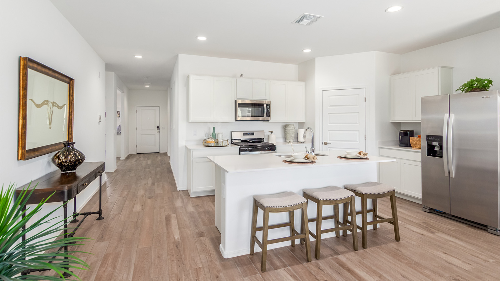 Experience the charm of The Cali, located within the peaceful Sycamore Vista community in the serene foothills of the Santa Rita Mountains, Arizona. This thoughtfully laid-out, single-story home offers 1,823 square feet of versatile living space designed to meet the needs of modern families.  Step into the inviting entryway, where you're welcomed by a spacious great room that serves as the heart of the home. The open-concept design connects the great room to the dining area and kitchen, creating a harmonious flow that's perfect for both entertaining and daily living. The kitchen is a true culinary haven, featuring a large island, quartz countertops, and ample storage space with a walk-in pantry.  The Cali's four bedrooms are designed with relaxation in mind. The primary suite, tucked away from the other bedrooms, offers a private oasis complete with a walk-in closet and en-suite bathroom. The additional three bedrooms share a well-equipped bathroom and are situated to provide comfort and privacy for family members or guests.  Adding to the home's appeal are the premium standard features that come included in every Cali at Sycamore Vista. Enjoy the elegance of staggered wood-look ceramic tile flooring throughout the main living areas, complemented by Shaker-style cabinetry in the kitchen and bathrooms. The kitchen is further enhanced by an open single basin stainless steel sink paired with a water filtration system, making both cooking and cleanup a breeze. The energy-efficient design includes spray foam insulation, a tankless water heater, and LED lighting throughout, all contributing to a more sustainable lifestyle.  Outdoor living is a breeze with the covered patio, easily accessible from the dining room, providing the perfect spot for morning coffee or evening gatherings. The three-car garage offers plenty of space for vehicles and storage, ensuring that everything you need is within easy reach.  Sycamore Vista's location offers a unique blend of tranquility and convenience, making The Cali an ideal choice for those seeking a peaceful retreat with easy access to modern amenities. Whether you're relaxing indoors or enjoying the outdoor beauty of Arizona, The Cali is a home that combines style, comfort, and functionality in every detail.  *Images shown are for reference only. They depict the Cali sales model home and may not represent the actual home.