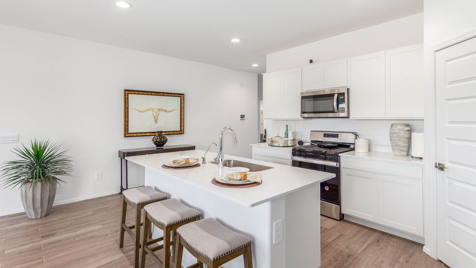 Experience the charm of The Cali, located within the peaceful Sycamore Vista community in the serene foothills of the Santa Rita Mountains, Arizona. This thoughtfully laid-out, single-story home offers 1,823 square feet of versatile living space designed to meet the needs of modern families.  Step into the inviting entryway, where you're welcomed by a spacious great room that serves as the heart of the home. The open-concept design connects the great room to the dining area and kitchen, creating a harmonious flow that's perfect for both entertaining and daily living. The kitchen is a true culinary haven, featuring a large island, quartz countertops, and ample storage space with a walk-in pantry.  The Cali's four bedrooms are designed with relaxation in mind. The primary suite, tucked away from the other bedrooms, offers a private oasis complete with a walk-in closet and en-suite bathroom. The additional three bedrooms share a well-equipped bathroom and are situated to provide comfort and privacy for family members or guests.  Adding to the home's appeal are the premium standard features that come included in every Cali at Sycamore Vista. Enjoy the elegance of staggered wood-look ceramic tile flooring throughout the main living areas, complemented by Shaker-style cabinetry in the kitchen and bathrooms. The kitchen is further enhanced by an open single basin stainless steel sink paired with a water filtration system, making both cooking and cleanup a breeze. The energy-efficient design includes spray foam insulation, a tankless water heater, and LED lighting throughout, all contributing to a more sustainable lifestyle.  Outdoor living is a breeze with the covered patio, easily accessible from the dining room, providing the perfect spot for morning coffee or evening gatherings. The three-car garage offers plenty of space for vehicles and storage, ensuring that everything you need is within easy reach.  Sycamore Vista's location offers a unique blend of tranquility and convenience, making The Cali an ideal choice for those seeking a peaceful retreat with easy access to modern amenities. Whether you're relaxing indoors or enjoying the outdoor beauty of Arizona, The Cali is a home that combines style, comfort, and functionality in every detail.  *Images shown are for reference only. They depict the Cali sales model home and may not represent the actual home.