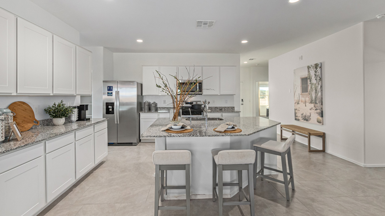 Welcome to the Kingston, a premier new home design situated in the picturesque Sycamore Vista community in Vail, Arizona. With an expansive 2,051 square feet of living space, this single-story home offers four bedrooms, two bathrooms, and a two-three car garage.  As you step inside, you are greeted by an inviting entryway that flows seamlessly into a heart of the home. The open-concept kitchen, equipped with a center island, modern appliances, and ample pantry space, makes it ideal for culinary adventures. Adjacent to the kitchen, the dining room offers easy access to the covered patio, where you can enjoy outdoor dining or simply relax in the tranquility of your private backyard.  The Kingston’s thoughtful layout ensures that every bedroom offers comfort and privacy. The primary suite, located at the rear of the home, features a large walk-in closet and an en-suite bathroom. The additional bedrooms are thoughtfully arranged to provide flexibility, whether you need a guest room, home office, or space for hobbies.  The Kingston is built with a focus on energy efficiency, featuring top-of-the-line insulation, energy-efficient appliances, and a smart home package that includes an automated thermostat, keyless entry, a Wi-Fi-enabled garage door opener, and more. This modern home not only offers comfort but also provides peace of mind with its energy-saving features and enhanced security systems.  Residents of Sycamore Vista enjoy a harmonious blend of rural tranquility and convenient urban access. With proximity to outdoor attractions like Coronado National Forest and Colossal Cave Mountain Park, as well as nearby schools and major employers, Sycamore Vista provides a unique living experience where nature and modern living coexist.  The Kingston at Sycamore Vista is more than just a house—it's a place to create lasting memories and live your best life.  *Images shown are for reference only. They depict the sales model home and may not represent the actual home.