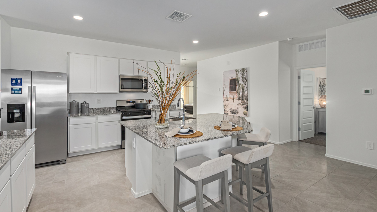 Welcome to the Kingston, a premier new home design situated in the picturesque Sycamore Vista community in Vail, Arizona. With an expansive 2,051 square feet of living space, this single-story home offers four bedrooms, two bathrooms, and a two-three car garage.  As you step inside, you are greeted by an inviting entryway that flows seamlessly into a heart of the home. The open-concept kitchen, equipped with a center island, modern appliances, and ample pantry space, makes it ideal for culinary adventures. Adjacent to the kitchen, the dining room offers easy access to the covered patio, where you can enjoy outdoor dining or simply relax in the tranquility of your private backyard.  The Kingston’s thoughtful layout ensures that every bedroom offers comfort and privacy. The primary suite, located at the rear of the home, features a large walk-in closet and an en-suite bathroom. The additional bedrooms are thoughtfully arranged to provide flexibility, whether you need a guest room, home office, or space for hobbies.  The Kingston is built with a focus on energy efficiency, featuring top-of-the-line insulation, energy-efficient appliances, and a smart home package that includes an automated thermostat, keyless entry, a Wi-Fi-enabled garage door opener, and more. This modern home not only offers comfort but also provides peace of mind with its energy-saving features and enhanced security systems.  Residents of Sycamore Vista enjoy a harmonious blend of rural tranquility and convenient urban access. With proximity to outdoor attractions like Coronado National Forest and Colossal Cave Mountain Park, as well as nearby schools and major employers, Sycamore Vista provides a unique living experience where nature and modern living coexist.  The Kingston at Sycamore Vista is more than just a house—it's a place to create lasting memories and live your best life.  *Images shown are for reference only. They depict the sales model home and may not represent the actual home.