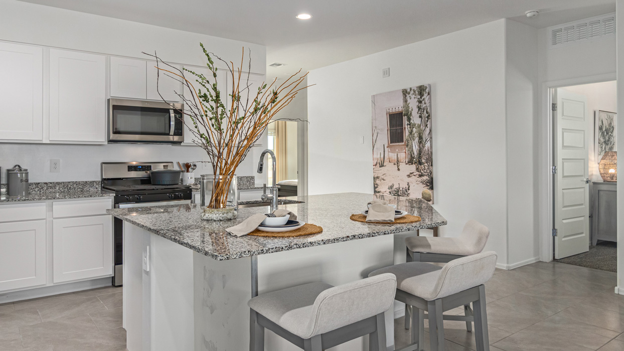 Welcome to the Kingston, a premier new home design situated in the picturesque Sycamore Vista community in Vail, Arizona. With an expansive 2,051 square feet of living space, this single-story home offers four bedrooms, two bathrooms, and a two-three car garage.  As you step inside, you are greeted by an inviting entryway that flows seamlessly into a heart of the home. The open-concept kitchen, equipped with a center island, modern appliances, and ample pantry space, makes it ideal for culinary adventures. Adjacent to the kitchen, the dining room offers easy access to the covered patio, where you can enjoy outdoor dining or simply relax in the tranquility of your private backyard.  The Kingston’s thoughtful layout ensures that every bedroom offers comfort and privacy. The primary suite, located at the rear of the home, features a large walk-in closet and an en-suite bathroom. The additional bedrooms are thoughtfully arranged to provide flexibility, whether you need a guest room, home office, or space for hobbies.  The Kingston is built with a focus on energy efficiency, featuring top-of-the-line insulation, energy-efficient appliances, and a smart home package that includes an automated thermostat, keyless entry, a Wi-Fi-enabled garage door opener, and more. This modern home not only offers comfort but also provides peace of mind with its energy-saving features and enhanced security systems.  Residents of Sycamore Vista enjoy a harmonious blend of rural tranquility and convenient urban access. With proximity to outdoor attractions like Coronado National Forest and Colossal Cave Mountain Park, as well as nearby schools and major employers, Sycamore Vista provides a unique living experience where nature and modern living coexist.  The Kingston at Sycamore Vista is more than just a house—it's a place to create lasting memories and live your best life.  *Images shown are for reference only. They depict the sales model home and may not represent the actual home.