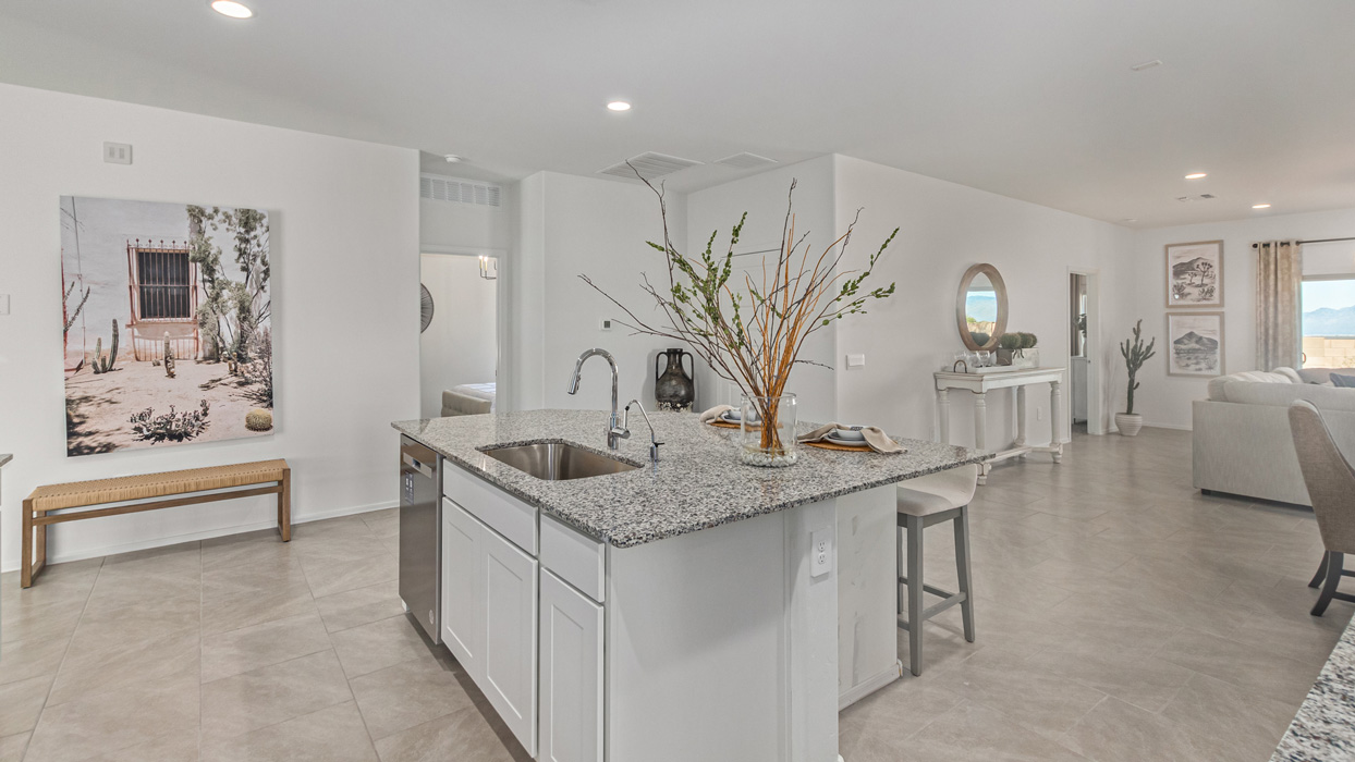 Welcome to the Kingston, a premier new home design situated in the picturesque Sycamore Vista community in Vail, Arizona. With an expansive 2,051 square feet of living space, this single-story home offers four bedrooms, two bathrooms, and a two-three car garage.  As you step inside, you are greeted by an inviting entryway that flows seamlessly into a heart of the home. The open-concept kitchen, equipped with a center island, modern appliances, and ample pantry space, makes it ideal for culinary adventures. Adjacent to the kitchen, the dining room offers easy access to the covered patio, where you can enjoy outdoor dining or simply relax in the tranquility of your private backyard.  The Kingston’s thoughtful layout ensures that every bedroom offers comfort and privacy. The primary suite, located at the rear of the home, features a large walk-in closet and an en-suite bathroom. The additional bedrooms are thoughtfully arranged to provide flexibility, whether you need a guest room, home office, or space for hobbies.  The Kingston is built with a focus on energy efficiency, featuring top-of-the-line insulation, energy-efficient appliances, and a smart home package that includes an automated thermostat, keyless entry, a Wi-Fi-enabled garage door opener, and more. This modern home not only offers comfort but also provides peace of mind with its energy-saving features and enhanced security systems.  Residents of Sycamore Vista enjoy a harmonious blend of rural tranquility and convenient urban access. With proximity to outdoor attractions like Coronado National Forest and Colossal Cave Mountain Park, as well as nearby schools and major employers, Sycamore Vista provides a unique living experience where nature and modern living coexist.  The Kingston at Sycamore Vista is more than just a house—it's a place to create lasting memories and live your best life.  *Images shown are for reference only. They depict the sales model home and may not represent the actual home.