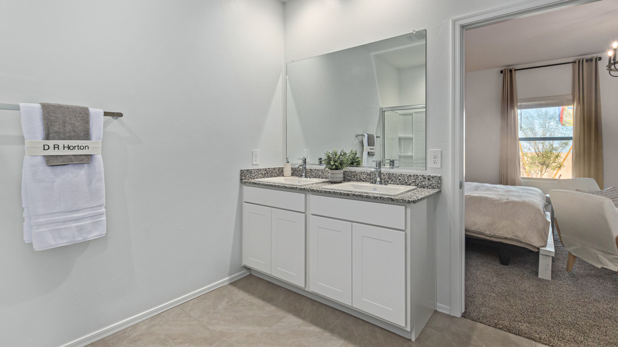 Welcome to the Kingston, a premier new home design situated in the picturesque Sycamore Vista community in Vail, Arizona. With an expansive 2,051 square feet of living space, this single-story home offers four bedrooms, two bathrooms, and a two-three car garage.  As you step inside, you are greeted by an inviting entryway that flows seamlessly into a heart of the home. The open-concept kitchen, equipped with a center island, modern appliances, and ample pantry space, makes it ideal for culinary adventures. Adjacent to the kitchen, the dining room offers easy access to the covered patio, where you can enjoy outdoor dining or simply relax in the tranquility of your private backyard.  The Kingston’s thoughtful layout ensures that every bedroom offers comfort and privacy. The primary suite, located at the rear of the home, features a large walk-in closet and an en-suite bathroom. The additional bedrooms are thoughtfully arranged to provide flexibility, whether you need a guest room, home office, or space for hobbies.  The Kingston is built with a focus on energy efficiency, featuring top-of-the-line insulation, energy-efficient appliances, and a smart home package that includes an automated thermostat, keyless entry, a Wi-Fi-enabled garage door opener, and more. This modern home not only offers comfort but also provides peace of mind with its energy-saving features and enhanced security systems.  Residents of Sycamore Vista enjoy a harmonious blend of rural tranquility and convenient urban access. With proximity to outdoor attractions like Coronado National Forest and Colossal Cave Mountain Park, as well as nearby schools and major employers, Sycamore Vista provides a unique living experience where nature and modern living coexist.  The Kingston at Sycamore Vista is more than just a house—it's a place to create lasting memories and live your best life.  *Images shown are for reference only. They depict the sales model home and may not represent the actual home.