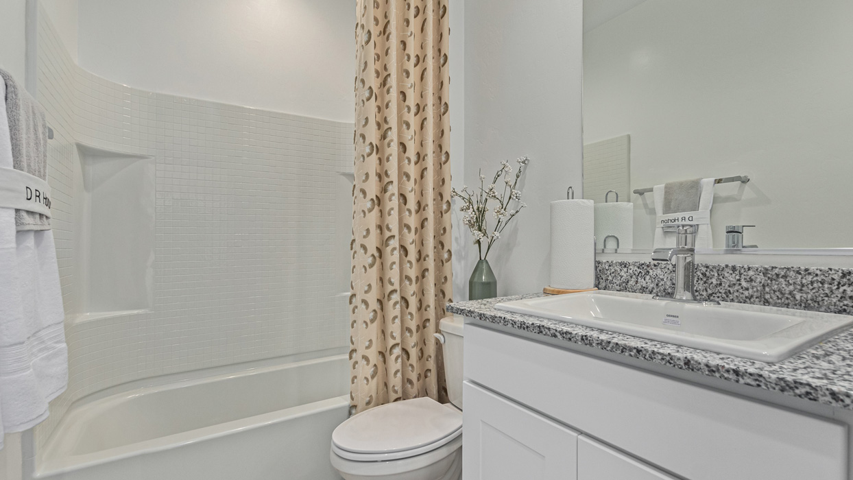 Welcome to the Kingston, a premier new home design situated in the picturesque Sycamore Vista community in Vail, Arizona. With an expansive 2,051 square feet of living space, this single-story home offers four bedrooms, two bathrooms, and a two-three car garage.  As you step inside, you are greeted by an inviting entryway that flows seamlessly into a heart of the home. The open-concept kitchen, equipped with a center island, modern appliances, and ample pantry space, makes it ideal for culinary adventures. Adjacent to the kitchen, the dining room offers easy access to the covered patio, where you can enjoy outdoor dining or simply relax in the tranquility of your private backyard.  The Kingston’s thoughtful layout ensures that every bedroom offers comfort and privacy. The primary suite, located at the rear of the home, features a large walk-in closet and an en-suite bathroom. The additional bedrooms are thoughtfully arranged to provide flexibility, whether you need a guest room, home office, or space for hobbies.  The Kingston is built with a focus on energy efficiency, featuring top-of-the-line insulation, energy-efficient appliances, and a smart home package that includes an automated thermostat, keyless entry, a Wi-Fi-enabled garage door opener, and more. This modern home not only offers comfort but also provides peace of mind with its energy-saving features and enhanced security systems.  Residents of Sycamore Vista enjoy a harmonious blend of rural tranquility and convenient urban access. With proximity to outdoor attractions like Coronado National Forest and Colossal Cave Mountain Park, as well as nearby schools and major employers, Sycamore Vista provides a unique living experience where nature and modern living coexist.  The Kingston at Sycamore Vista is more than just a house—it's a place to create lasting memories and live your best life.  *Images shown are for reference only. They depict the sales model home and may not represent the actual home.