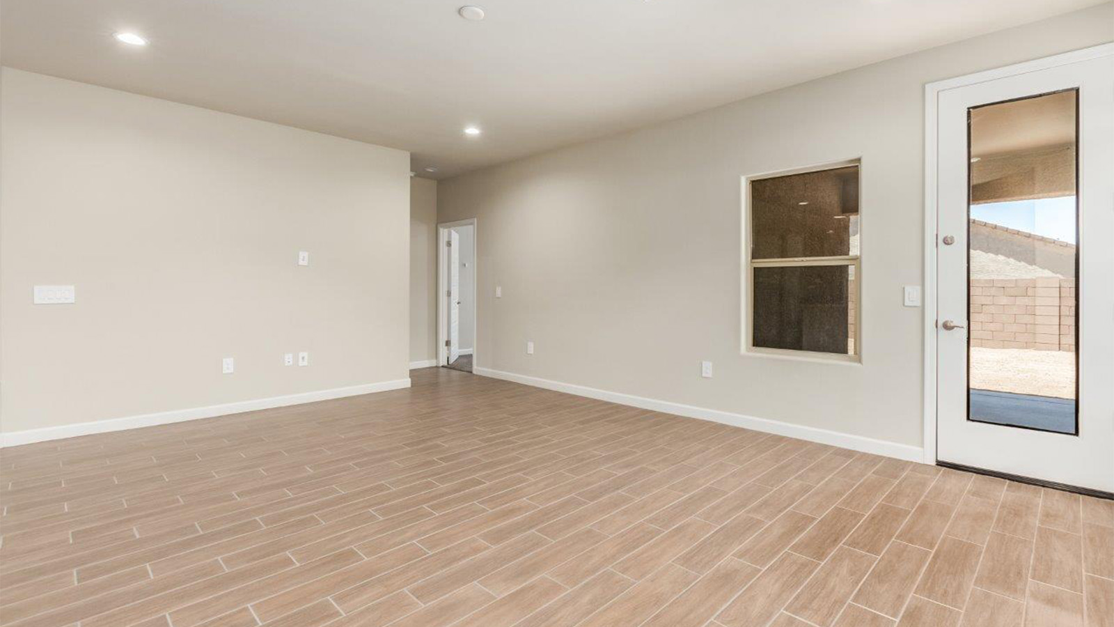 The Lakeway, situated within the beautiful Sycamore Vista community in Vail, Arizona, offers a perfect blend of functionality and comfort, ideal for both growing families and those who appreciate spacious living. With its 2,034 square feet of living space, this single-story new home features five bedrooms and three bathrooms, all meticulously designed to maximize space and convenience.  Entering The Lakeway offers a bright and airy atmosphere that flows through the open-concept floor plan. The heart of the home is the great room, seamlessly connected to the kitchen and dining area. The kitchen is equipped with quartz countertops, Shaker-style cabinetry, and a large island that serves as a focal point for both meal preparation and casual gatherings. The adjoining dining room provides a cozy space for family meals, with easy access to the covered patio through sliding glass doors, creating a wonderful indoor-outdoor living experience.  The primary bedroom is a true retreat, offering a spacious walk-in closet and an en-suite bathroom with a dual-sink vanity and an elegant, tiled shower. The additional bedrooms are thoughtfully spaced to provide ample privacy for family members or guests, and the two secondary bathrooms are finished with modern fixtures and plenty of storage. This home offers a 2-3 car garage option for substantial space of vehicles and storage, accommodating the practical needs of busy households.  Standard features in The Lakeway at Sycamore Vista include energy-efficient elements like a tankless water heater, spray foam insulation, and LED lighting throughout. The home also comes with a Home is Connected® Smart Home package, which includes a smart thermostat, video doorbell, keyless entry, and more, ensuring modern conveniences are at your fingertips. The front yard is beautifully landscaped and includes an auto drip irrigation system, enhancing the curb appeal of this stunning home.  Nestled within Sycamore Vista, The Lakeway combines the tranquility of a rural setting with proximity to excellent schools, shopping, dining, and outdoor recreation, making it an exceptional place to call home.