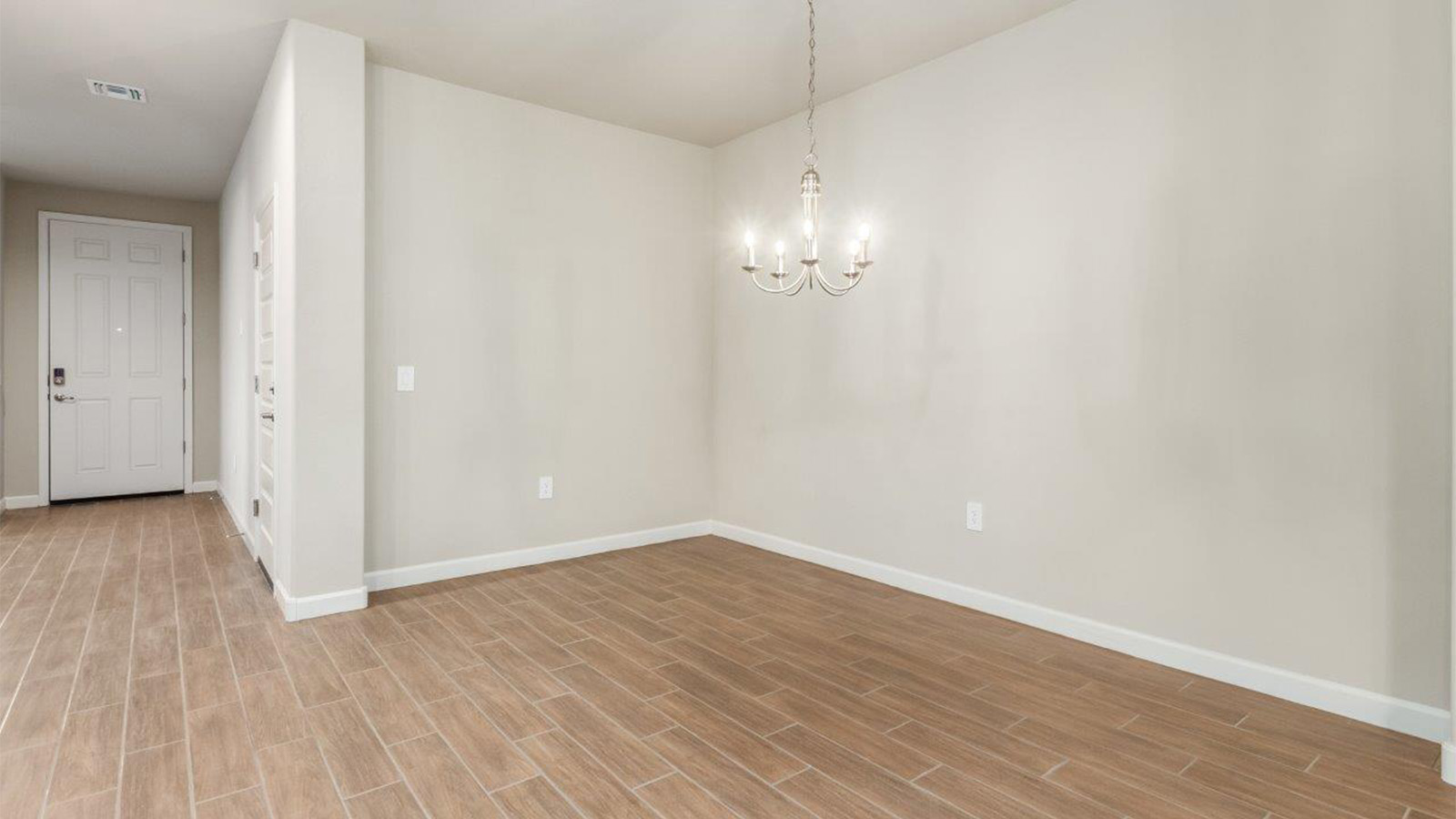 The Lakeway, situated within the beautiful Sycamore Vista community in Vail, Arizona, offers a perfect blend of functionality and comfort, ideal for both growing families and those who appreciate spacious living. With its 2,034 square feet of living space, this single-story new home features five bedrooms and three bathrooms, all meticulously designed to maximize space and convenience.  Entering The Lakeway offers a bright and airy atmosphere that flows through the open-concept floor plan. The heart of the home is the great room, seamlessly connected to the kitchen and dining area. The kitchen is equipped with quartz countertops, Shaker-style cabinetry, and a large island that serves as a focal point for both meal preparation and casual gatherings. The adjoining dining room provides a cozy space for family meals, with easy access to the covered patio through sliding glass doors, creating a wonderful indoor-outdoor living experience.  The primary bedroom is a true retreat, offering a spacious walk-in closet and an en-suite bathroom with a dual-sink vanity and an elegant, tiled shower. The additional bedrooms are thoughtfully spaced to provide ample privacy for family members or guests, and the two secondary bathrooms are finished with modern fixtures and plenty of storage. This home offers a 2-3 car garage option for substantial space of vehicles and storage, accommodating the practical needs of busy households.  Standard features in The Lakeway at Sycamore Vista include energy-efficient elements like a tankless water heater, spray foam insulation, and LED lighting throughout. The home also comes with a Home is Connected® Smart Home package, which includes a smart thermostat, video doorbell, keyless entry, and more, ensuring modern conveniences are at your fingertips. The front yard is beautifully landscaped and includes an auto drip irrigation system, enhancing the curb appeal of this stunning home.  Nestled within Sycamore Vista, The Lakeway combines the tranquility of a rural setting with proximity to excellent schools, shopping, dining, and outdoor recreation, making it an exceptional place to call home.