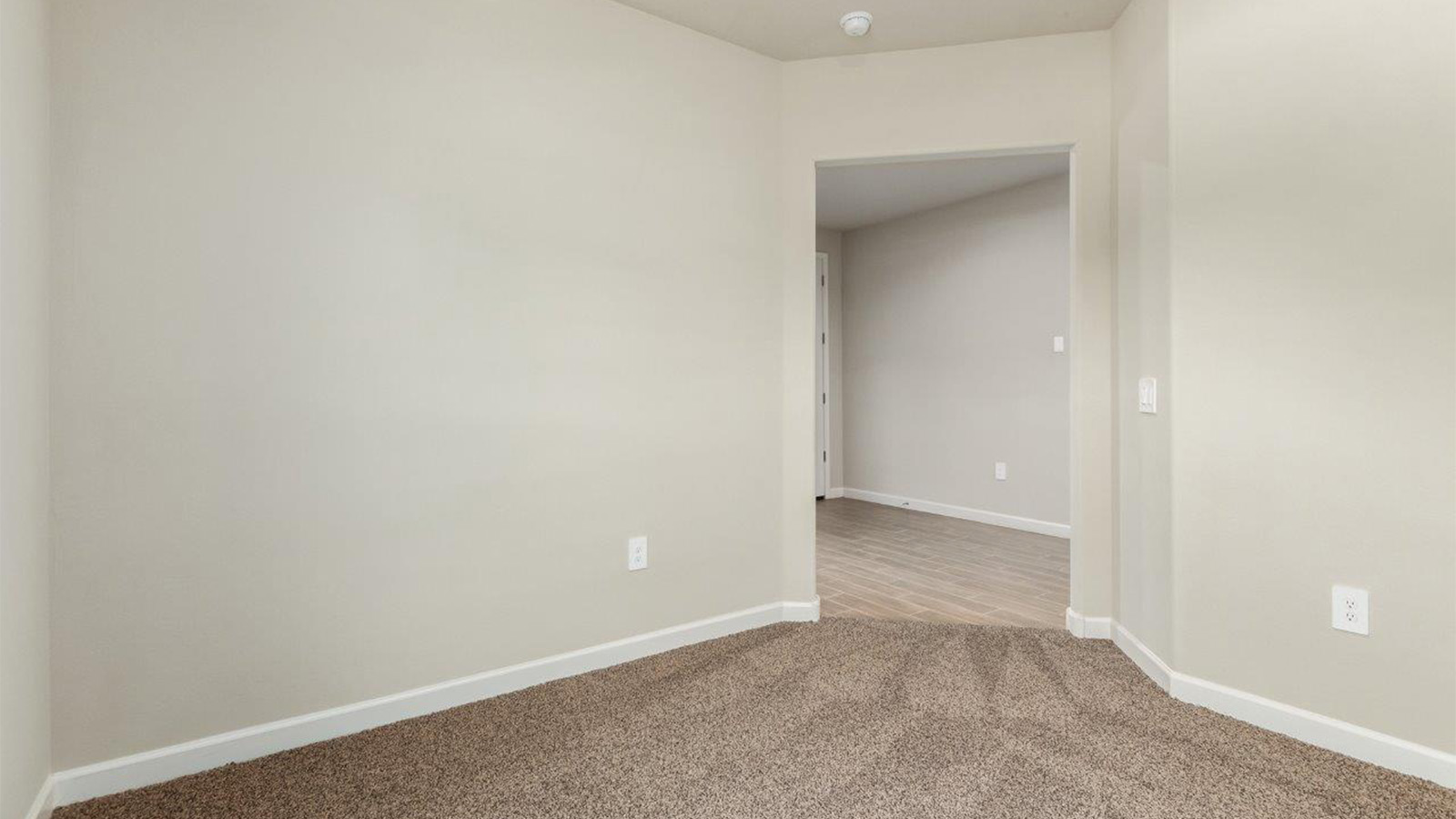 The Lakeway, situated within the beautiful Sycamore Vista community in Vail, Arizona, offers a perfect blend of functionality and comfort, ideal for both growing families and those who appreciate spacious living. With its 2,034 square feet of living space, this single-story new home features five bedrooms and three bathrooms, all meticulously designed to maximize space and convenience.  Entering The Lakeway offers a bright and airy atmosphere that flows through the open-concept floor plan. The heart of the home is the great room, seamlessly connected to the kitchen and dining area. The kitchen is equipped with quartz countertops, Shaker-style cabinetry, and a large island that serves as a focal point for both meal preparation and casual gatherings. The adjoining dining room provides a cozy space for family meals, with easy access to the covered patio through sliding glass doors, creating a wonderful indoor-outdoor living experience.  The primary bedroom is a true retreat, offering a spacious walk-in closet and an en-suite bathroom with a dual-sink vanity and an elegant, tiled shower. The additional bedrooms are thoughtfully spaced to provide ample privacy for family members or guests, and the two secondary bathrooms are finished with modern fixtures and plenty of storage. This home offers a 2-3 car garage option for substantial space of vehicles and storage, accommodating the practical needs of busy households.  Standard features in The Lakeway at Sycamore Vista include energy-efficient elements like a tankless water heater, spray foam insulation, and LED lighting throughout. The home also comes with a Home is Connected® Smart Home package, which includes a smart thermostat, video doorbell, keyless entry, and more, ensuring modern conveniences are at your fingertips. The front yard is beautifully landscaped and includes an auto drip irrigation system, enhancing the curb appeal of this stunning home.  Nestled within Sycamore Vista, The Lakeway combines the tranquility of a rural setting with proximity to excellent schools, shopping, dining, and outdoor recreation, making it an exceptional place to call home.