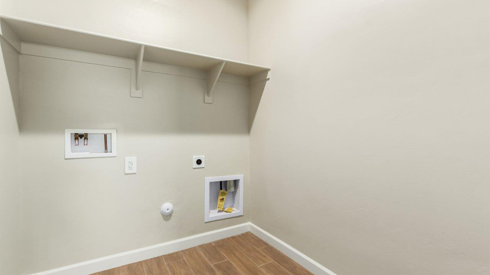 The Lakeway, situated within the beautiful Sycamore Vista community in Vail, Arizona, offers a perfect blend of functionality and comfort, ideal for both growing families and those who appreciate spacious living. With its 2,034 square feet of living space, this single-story new home features five bedrooms and three bathrooms, all meticulously designed to maximize space and convenience.  Entering The Lakeway offers a bright and airy atmosphere that flows through the open-concept floor plan. The heart of the home is the great room, seamlessly connected to the kitchen and dining area. The kitchen is equipped with quartz countertops, Shaker-style cabinetry, and a large island that serves as a focal point for both meal preparation and casual gatherings. The adjoining dining room provides a cozy space for family meals, with easy access to the covered patio through sliding glass doors, creating a wonderful indoor-outdoor living experience.  The primary bedroom is a true retreat, offering a spacious walk-in closet and an en-suite bathroom with a dual-sink vanity and an elegant, tiled shower. The additional bedrooms are thoughtfully spaced to provide ample privacy for family members or guests, and the two secondary bathrooms are finished with modern fixtures and plenty of storage. This home offers a 2-3 car garage option for substantial space of vehicles and storage, accommodating the practical needs of busy households.  Standard features in The Lakeway at Sycamore Vista include energy-efficient elements like a tankless water heater, spray foam insulation, and LED lighting throughout. The home also comes with a Home is Connected® Smart Home package, which includes a smart thermostat, video doorbell, keyless entry, and more, ensuring modern conveniences are at your fingertips. The front yard is beautifully landscaped and includes an auto drip irrigation system, enhancing the curb appeal of this stunning home.  Nestled within Sycamore Vista, The Lakeway combines the tranquility of a rural setting with proximity to excellent schools, shopping, dining, and outdoor recreation, making it an exceptional place to call home.