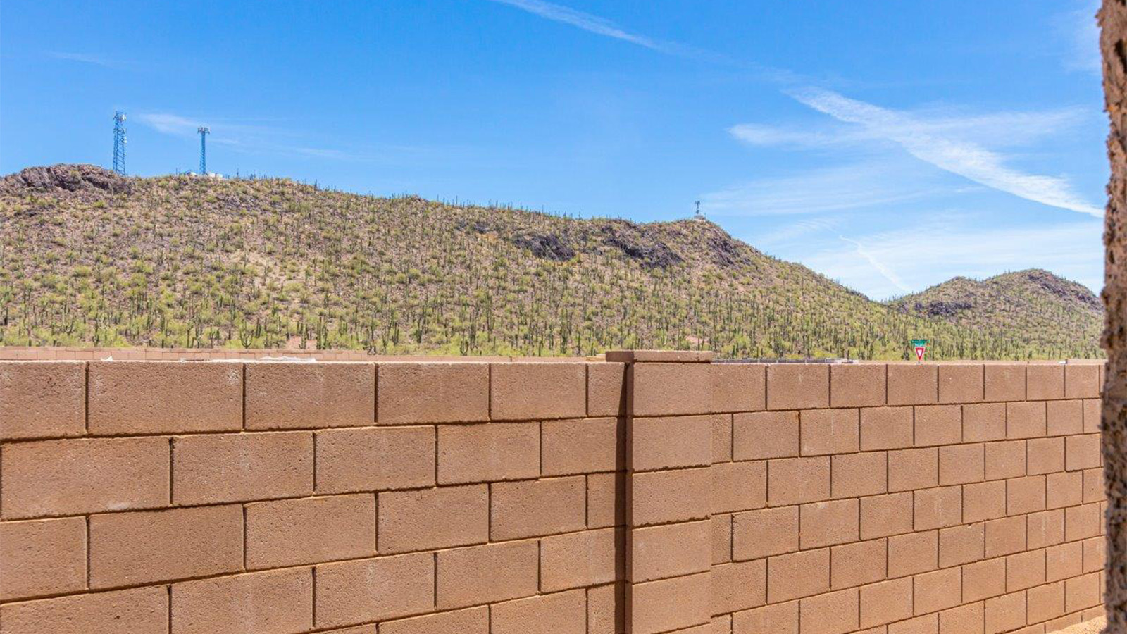 The Lakeway, situated within the beautiful Sycamore Vista community in Vail, Arizona, offers a perfect blend of functionality and comfort, ideal for both growing families and those who appreciate spacious living. With its 2,034 square feet of living space, this single-story new home features five bedrooms and three bathrooms, all meticulously designed to maximize space and convenience.  Entering The Lakeway offers a bright and airy atmosphere that flows through the open-concept floor plan. The heart of the home is the great room, seamlessly connected to the kitchen and dining area. The kitchen is equipped with quartz countertops, Shaker-style cabinetry, and a large island that serves as a focal point for both meal preparation and casual gatherings. The adjoining dining room provides a cozy space for family meals, with easy access to the covered patio through sliding glass doors, creating a wonderful indoor-outdoor living experience.  The primary bedroom is a true retreat, offering a spacious walk-in closet and an en-suite bathroom with a dual-sink vanity and an elegant, tiled shower. The additional bedrooms are thoughtfully spaced to provide ample privacy for family members or guests, and the two secondary bathrooms are finished with modern fixtures and plenty of storage. This home offers a 2-3 car garage option for substantial space of vehicles and storage, accommodating the practical needs of busy households.  Standard features in The Lakeway at Sycamore Vista include energy-efficient elements like a tankless water heater, spray foam insulation, and LED lighting throughout. The home also comes with a Home is Connected® Smart Home package, which includes a smart thermostat, video doorbell, keyless entry, and more, ensuring modern conveniences are at your fingertips. The front yard is beautifully landscaped and includes an auto drip irrigation system, enhancing the curb appeal of this stunning home.  Nestled within Sycamore Vista, The Lakeway combines the tranquility of a rural setting with proximity to excellent schools, shopping, dining, and outdoor recreation, making it an exceptional place to call home.