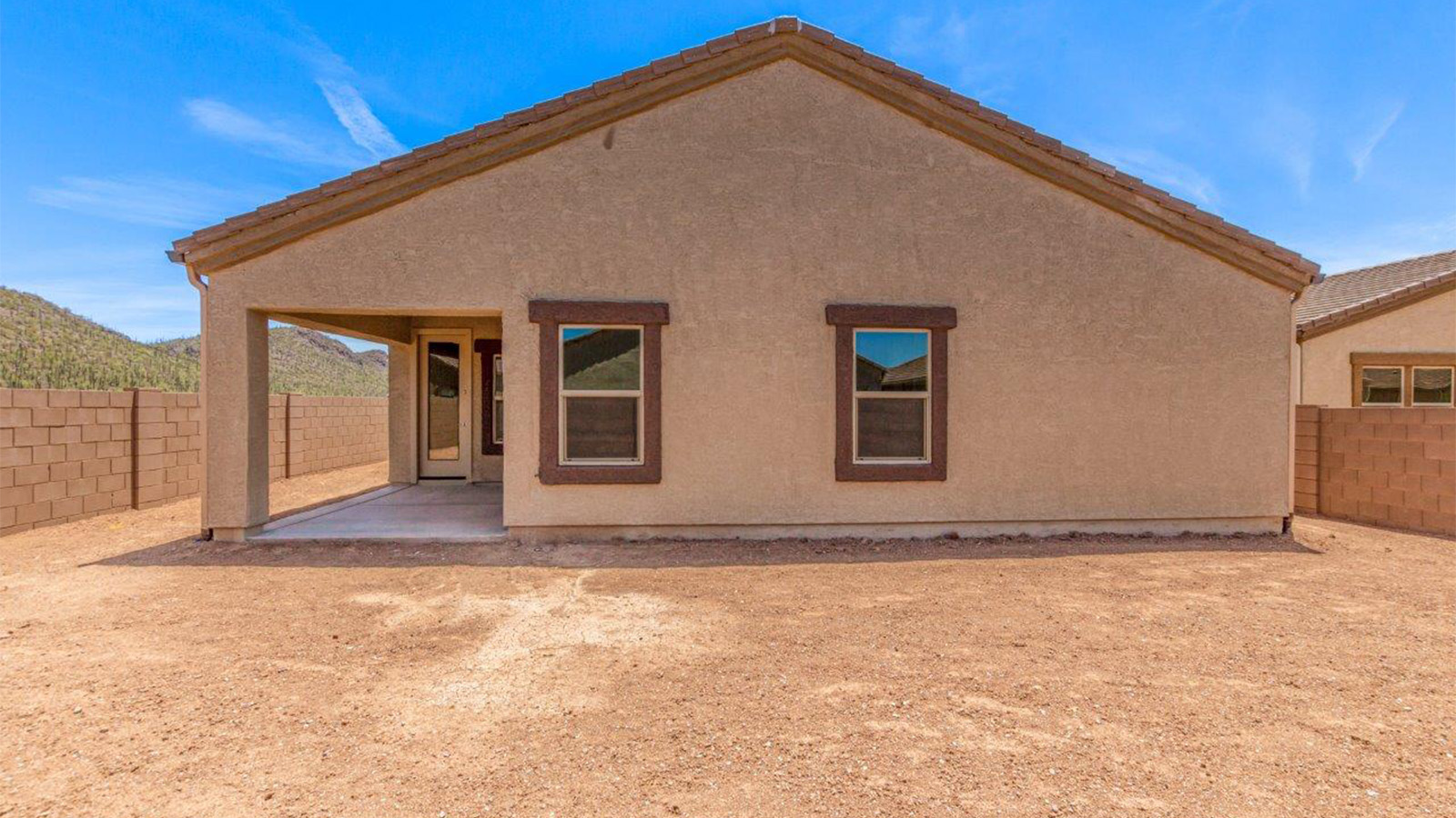 The Lakeway, situated within the beautiful Sycamore Vista community in Vail, Arizona, offers a perfect blend of functionality and comfort, ideal for both growing families and those who appreciate spacious living. With its 2,034 square feet of living space, this single-story new home features five bedrooms and three bathrooms, all meticulously designed to maximize space and convenience.  Entering The Lakeway offers a bright and airy atmosphere that flows through the open-concept floor plan. The heart of the home is the great room, seamlessly connected to the kitchen and dining area. The kitchen is equipped with quartz countertops, Shaker-style cabinetry, and a large island that serves as a focal point for both meal preparation and casual gatherings. The adjoining dining room provides a cozy space for family meals, with easy access to the covered patio through sliding glass doors, creating a wonderful indoor-outdoor living experience.  The primary bedroom is a true retreat, offering a spacious walk-in closet and an en-suite bathroom with a dual-sink vanity and an elegant, tiled shower. The additional bedrooms are thoughtfully spaced to provide ample privacy for family members or guests, and the two secondary bathrooms are finished with modern fixtures and plenty of storage. This home offers a 2-3 car garage option for substantial space of vehicles and storage, accommodating the practical needs of busy households.  Standard features in The Lakeway at Sycamore Vista include energy-efficient elements like a tankless water heater, spray foam insulation, and LED lighting throughout. The home also comes with a Home is Connected® Smart Home package, which includes a smart thermostat, video doorbell, keyless entry, and more, ensuring modern conveniences are at your fingertips. The front yard is beautifully landscaped and includes an auto drip irrigation system, enhancing the curb appeal of this stunning home.  Nestled within Sycamore Vista, The Lakeway combines the tranquility of a rural setting with proximity to excellent schools, shopping, dining, and outdoor recreation, making it an exceptional place to call home.