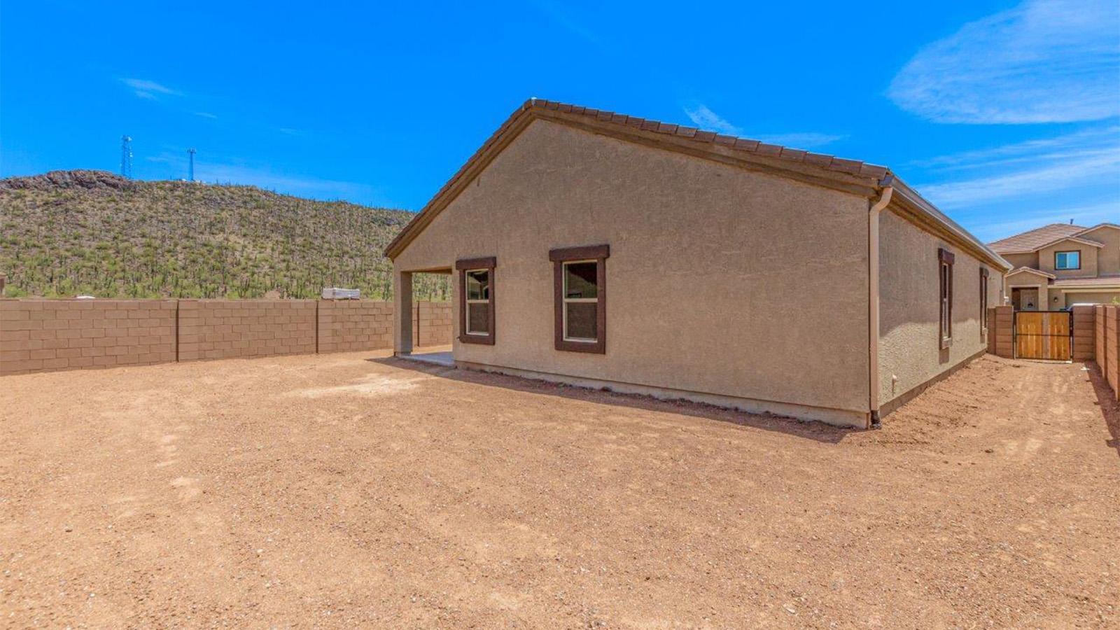 The Lakeway, situated within the beautiful Sycamore Vista community in Vail, Arizona, offers a perfect blend of functionality and comfort, ideal for both growing families and those who appreciate spacious living. With its 2,034 square feet of living space, this single-story new home features five bedrooms and three bathrooms, all meticulously designed to maximize space and convenience.  Entering The Lakeway offers a bright and airy atmosphere that flows through the open-concept floor plan. The heart of the home is the great room, seamlessly connected to the kitchen and dining area. The kitchen is equipped with quartz countertops, Shaker-style cabinetry, and a large island that serves as a focal point for both meal preparation and casual gatherings. The adjoining dining room provides a cozy space for family meals, with easy access to the covered patio through sliding glass doors, creating a wonderful indoor-outdoor living experience.  The primary bedroom is a true retreat, offering a spacious walk-in closet and an en-suite bathroom with a dual-sink vanity and an elegant, tiled shower. The additional bedrooms are thoughtfully spaced to provide ample privacy for family members or guests, and the two secondary bathrooms are finished with modern fixtures and plenty of storage. This home offers a 2-3 car garage option for substantial space of vehicles and storage, accommodating the practical needs of busy households.  Standard features in The Lakeway at Sycamore Vista include energy-efficient elements like a tankless water heater, spray foam insulation, and LED lighting throughout. The home also comes with a Home is Connected® Smart Home package, which includes a smart thermostat, video doorbell, keyless entry, and more, ensuring modern conveniences are at your fingertips. The front yard is beautifully landscaped and includes an auto drip irrigation system, enhancing the curb appeal of this stunning home.  Nestled within Sycamore Vista, The Lakeway combines the tranquility of a rural setting with proximity to excellent schools, shopping, dining, and outdoor recreation, making it an exceptional place to call home.