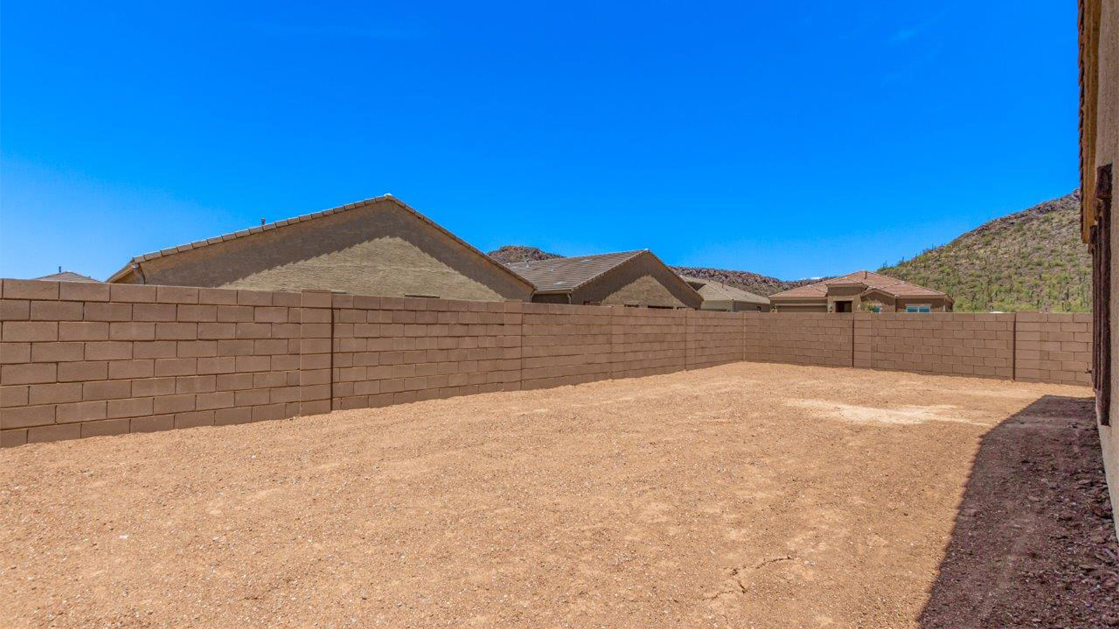 The Lakeway, situated within the beautiful Sycamore Vista community in Vail, Arizona, offers a perfect blend of functionality and comfort, ideal for both growing families and those who appreciate spacious living. With its 2,034 square feet of living space, this single-story new home features five bedrooms and three bathrooms, all meticulously designed to maximize space and convenience.  Entering The Lakeway offers a bright and airy atmosphere that flows through the open-concept floor plan. The heart of the home is the great room, seamlessly connected to the kitchen and dining area. The kitchen is equipped with quartz countertops, Shaker-style cabinetry, and a large island that serves as a focal point for both meal preparation and casual gatherings. The adjoining dining room provides a cozy space for family meals, with easy access to the covered patio through sliding glass doors, creating a wonderful indoor-outdoor living experience.  The primary bedroom is a true retreat, offering a spacious walk-in closet and an en-suite bathroom with a dual-sink vanity and an elegant, tiled shower. The additional bedrooms are thoughtfully spaced to provide ample privacy for family members or guests, and the two secondary bathrooms are finished with modern fixtures and plenty of storage. This home offers a 2-3 car garage option for substantial space of vehicles and storage, accommodating the practical needs of busy households.  Standard features in The Lakeway at Sycamore Vista include energy-efficient elements like a tankless water heater, spray foam insulation, and LED lighting throughout. The home also comes with a Home is Connected® Smart Home package, which includes a smart thermostat, video doorbell, keyless entry, and more, ensuring modern conveniences are at your fingertips. The front yard is beautifully landscaped and includes an auto drip irrigation system, enhancing the curb appeal of this stunning home.  Nestled within Sycamore Vista, The Lakeway combines the tranquility of a rural setting with proximity to excellent schools, shopping, dining, and outdoor recreation, making it an exceptional place to call home.