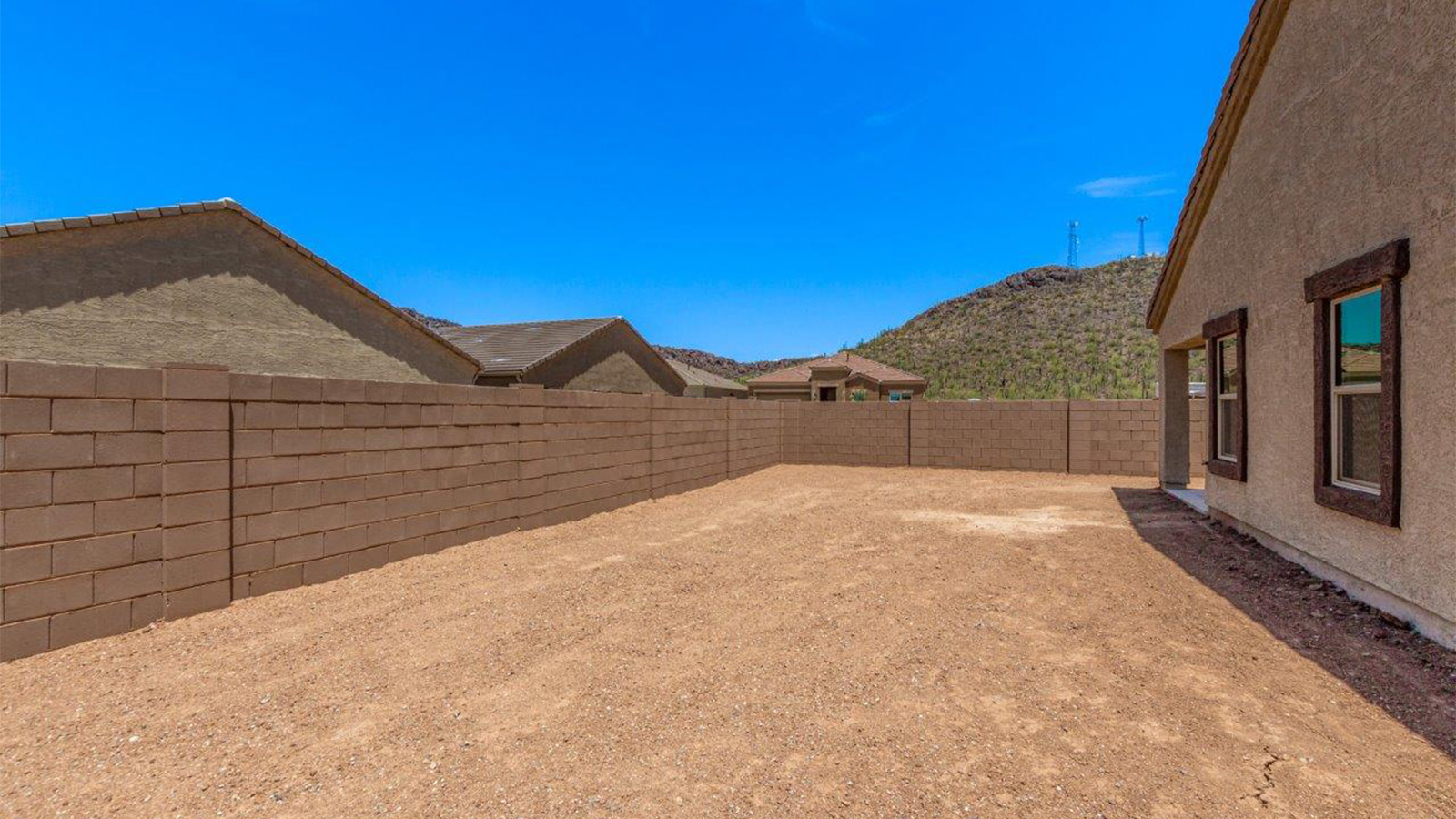 The Lakeway, situated within the beautiful Sycamore Vista community in Vail, Arizona, offers a perfect blend of functionality and comfort, ideal for both growing families and those who appreciate spacious living. With its 2,034 square feet of living space, this single-story new home features five bedrooms and three bathrooms, all meticulously designed to maximize space and convenience.  Entering The Lakeway offers a bright and airy atmosphere that flows through the open-concept floor plan. The heart of the home is the great room, seamlessly connected to the kitchen and dining area. The kitchen is equipped with quartz countertops, Shaker-style cabinetry, and a large island that serves as a focal point for both meal preparation and casual gatherings. The adjoining dining room provides a cozy space for family meals, with easy access to the covered patio through sliding glass doors, creating a wonderful indoor-outdoor living experience.  The primary bedroom is a true retreat, offering a spacious walk-in closet and an en-suite bathroom with a dual-sink vanity and an elegant, tiled shower. The additional bedrooms are thoughtfully spaced to provide ample privacy for family members or guests, and the two secondary bathrooms are finished with modern fixtures and plenty of storage. This home offers a 2-3 car garage option for substantial space of vehicles and storage, accommodating the practical needs of busy households.  Standard features in The Lakeway at Sycamore Vista include energy-efficient elements like a tankless water heater, spray foam insulation, and LED lighting throughout. The home also comes with a Home is Connected® Smart Home package, which includes a smart thermostat, video doorbell, keyless entry, and more, ensuring modern conveniences are at your fingertips. The front yard is beautifully landscaped and includes an auto drip irrigation system, enhancing the curb appeal of this stunning home.  Nestled within Sycamore Vista, The Lakeway combines the tranquility of a rural setting with proximity to excellent schools, shopping, dining, and outdoor recreation, making it an exceptional place to call home.