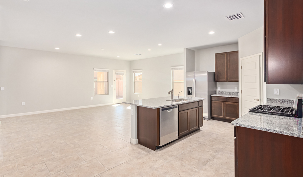 The Lakeway, situated within the beautiful Sycamore Vista community in Vail, Arizona, offers a perfect blend of functionality and comfort, ideal for both growing families and those who appreciate spacious living. With its 2,034 square feet of living space, this single-story new home features five bedrooms and three bathrooms, all meticulously designed to maximize space and convenience.  Entering The Lakeway, you’ll immediately notice the bright and airy atmosphere that flows through the open-concept floor plan. The heart of the home is the great room, seamlessly connected to the kitchen and dining area. The kitchen is equipped with quartz countertops, Shaker-style cabinetry, and a large island that serves as a focal point for both meal preparation and casual gatherings.  The primary bedroom is a true retreat, offering a spacious walk-in closet and an en-suite bathroom. The additional bedrooms are thoughtfully spaced to provide ample privacy for family members or guests, and the two secondary bathrooms are finished with modern fixtures and plenty of storage. This home offers a three-car garage option for substantial space of vehicles and storage, accommodating the practical needs of busy households.  Standard features in The Lakeway at Sycamore Vista include energy-efficient elements like a tankless water heater, spray foam insulation, and LED lighting throughout. The home also comes with a Home is Connected® Smart Home package, which includes a smart thermostat, video doorbell, keyless entry, and more, ensuring modern conveniences are at your fingertips. The front yard is beautifully landscaped and includes an auto drip irrigation system, enhancing the curb appeal of this stunning home.  Nestled within Sycamore Vista, The Lakeway combines the tranquility of a rural setting with proximity to excellent schools, shopping, dining, and outdoor recreation, making it an exceptional place to call home.  *Images shown are for reference only. They depict the model home and may not represent the actual home.