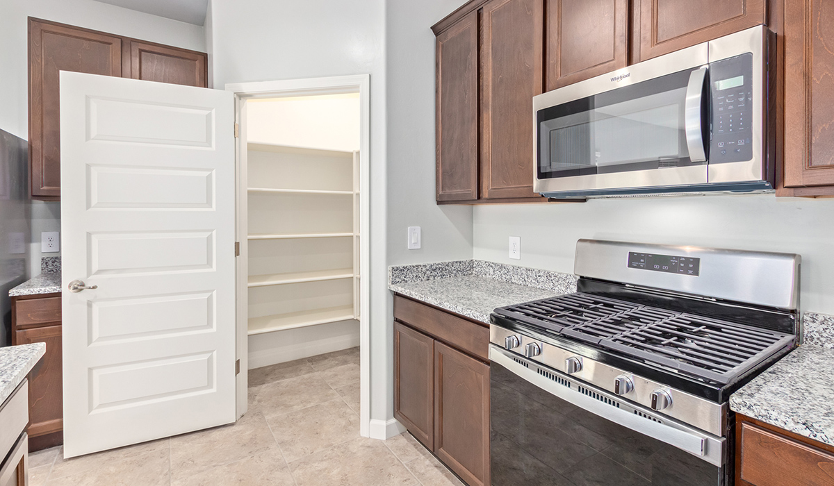 The Lakeway, situated within the beautiful Sycamore Vista community in Vail, Arizona, offers a perfect blend of functionality and comfort, ideal for both growing families and those who appreciate spacious living. With its 2,034 square feet of living space, this single-story new home features five bedrooms and three bathrooms, all meticulously designed to maximize space and convenience.  Entering The Lakeway, you’ll immediately notice the bright and airy atmosphere that flows through the open-concept floor plan. The heart of the home is the great room, seamlessly connected to the kitchen and dining area. The kitchen is equipped with quartz countertops, Shaker-style cabinetry, and a large island that serves as a focal point for both meal preparation and casual gatherings.  The primary bedroom is a true retreat, offering a spacious walk-in closet and an en-suite bathroom. The additional bedrooms are thoughtfully spaced to provide ample privacy for family members or guests, and the two secondary bathrooms are finished with modern fixtures and plenty of storage. This home offers a three-car garage option for substantial space of vehicles and storage, accommodating the practical needs of busy households.  Standard features in The Lakeway at Sycamore Vista include energy-efficient elements like a tankless water heater, spray foam insulation, and LED lighting throughout. The home also comes with a Home is Connected® Smart Home package, which includes a smart thermostat, video doorbell, keyless entry, and more, ensuring modern conveniences are at your fingertips. The front yard is beautifully landscaped and includes an auto drip irrigation system, enhancing the curb appeal of this stunning home.  Nestled within Sycamore Vista, The Lakeway combines the tranquility of a rural setting with proximity to excellent schools, shopping, dining, and outdoor recreation, making it an exceptional place to call home.  *Images shown are for reference only. They depict the model home and may not represent the actual home.