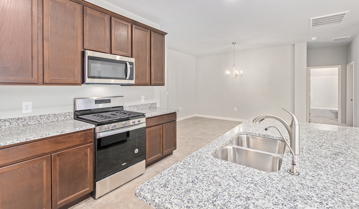 The Lakeway, situated within the beautiful Sycamore Vista community in Vail, Arizona, offers a perfect blend of functionality and comfort, ideal for both growing families and those who appreciate spacious living. With its 2,034 square feet of living space, this single-story new home features five bedrooms and three bathrooms, all meticulously designed to maximize space and convenience.  Entering The Lakeway, you’ll immediately notice the bright and airy atmosphere that flows through the open-concept floor plan. The heart of the home is the great room, seamlessly connected to the kitchen and dining area. The kitchen is equipped with quartz countertops, Shaker-style cabinetry, and a large island that serves as a focal point for both meal preparation and casual gatherings.  The primary bedroom is a true retreat, offering a spacious walk-in closet and an en-suite bathroom. The additional bedrooms are thoughtfully spaced to provide ample privacy for family members or guests, and the two secondary bathrooms are finished with modern fixtures and plenty of storage. This home offers a three-car garage option for substantial space of vehicles and storage, accommodating the practical needs of busy households.  Standard features in The Lakeway at Sycamore Vista include energy-efficient elements like a tankless water heater, spray foam insulation, and LED lighting throughout. The home also comes with a Home is Connected® Smart Home package, which includes a smart thermostat, video doorbell, keyless entry, and more, ensuring modern conveniences are at your fingertips. The front yard is beautifully landscaped and includes an auto drip irrigation system, enhancing the curb appeal of this stunning home.  Nestled within Sycamore Vista, The Lakeway combines the tranquility of a rural setting with proximity to excellent schools, shopping, dining, and outdoor recreation, making it an exceptional place to call home.  *Images shown are for reference only. They depict the model home and may not represent the actual home.