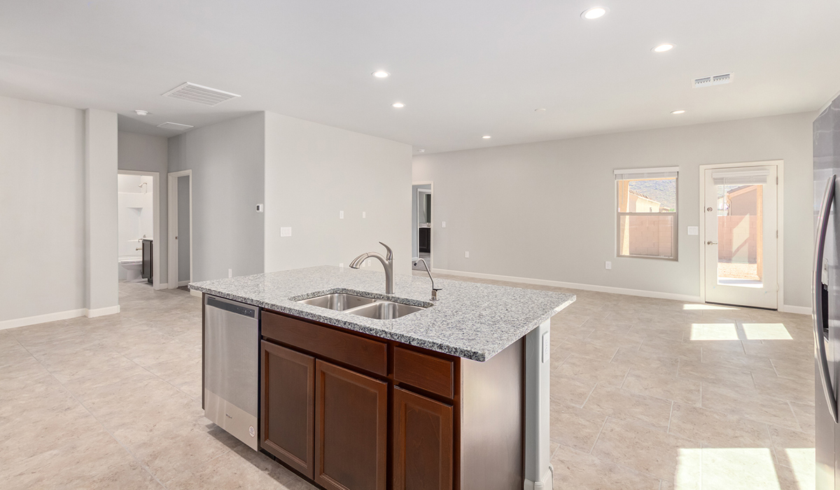 The Lakeway, situated within the beautiful Sycamore Vista community in Vail, Arizona, offers a perfect blend of functionality and comfort, ideal for both growing families and those who appreciate spacious living. With its 2,034 square feet of living space, this single-story new home features five bedrooms and three bathrooms, all meticulously designed to maximize space and convenience.  Entering The Lakeway, you’ll immediately notice the bright and airy atmosphere that flows through the open-concept floor plan. The heart of the home is the great room, seamlessly connected to the kitchen and dining area. The kitchen is equipped with quartz countertops, Shaker-style cabinetry, and a large island that serves as a focal point for both meal preparation and casual gatherings.  The primary bedroom is a true retreat, offering a spacious walk-in closet and an en-suite bathroom. The additional bedrooms are thoughtfully spaced to provide ample privacy for family members or guests, and the two secondary bathrooms are finished with modern fixtures and plenty of storage. This home offers a three-car garage option for substantial space of vehicles and storage, accommodating the practical needs of busy households.  Standard features in The Lakeway at Sycamore Vista include energy-efficient elements like a tankless water heater, spray foam insulation, and LED lighting throughout. The home also comes with a Home is Connected® Smart Home package, which includes a smart thermostat, video doorbell, keyless entry, and more, ensuring modern conveniences are at your fingertips. The front yard is beautifully landscaped and includes an auto drip irrigation system, enhancing the curb appeal of this stunning home.  Nestled within Sycamore Vista, The Lakeway combines the tranquility of a rural setting with proximity to excellent schools, shopping, dining, and outdoor recreation, making it an exceptional place to call home.  *Images shown are for reference only. They depict the model home and may not represent the actual home.