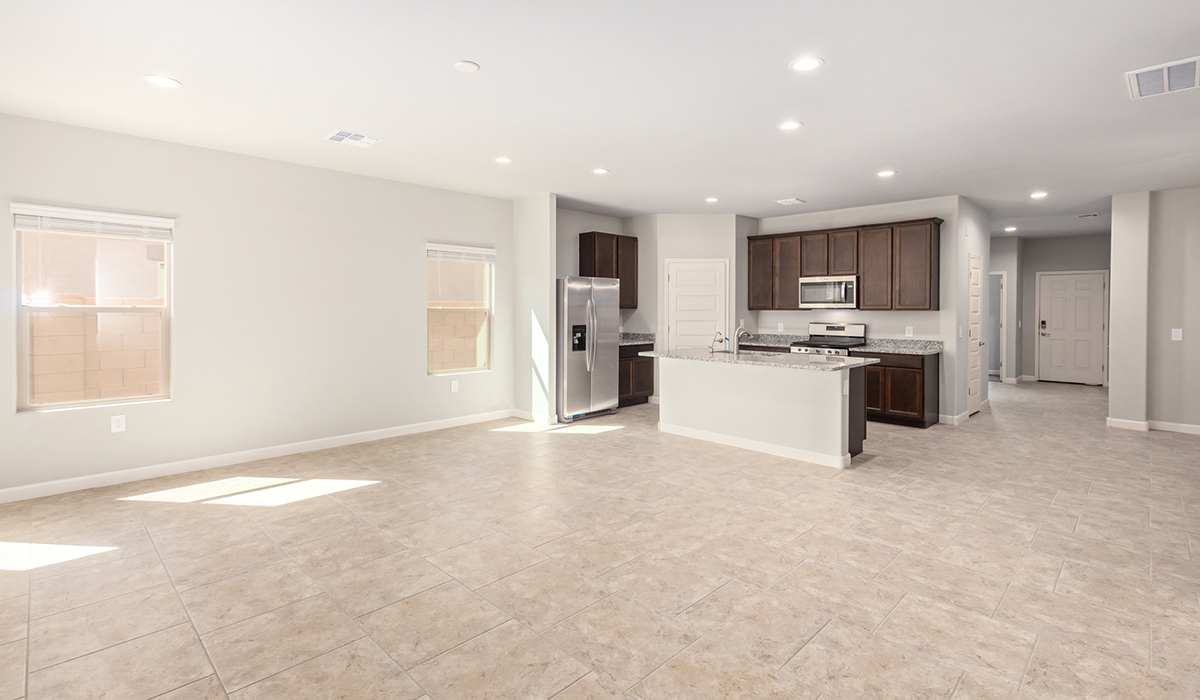 The Lakeway, situated within the beautiful Sycamore Vista community in Vail, Arizona, offers a perfect blend of functionality and comfort, ideal for both growing families and those who appreciate spacious living. With its 2,034 square feet of living space, this single-story new home features five bedrooms and three bathrooms, all meticulously designed to maximize space and convenience.  Entering The Lakeway, you’ll immediately notice the bright and airy atmosphere that flows through the open-concept floor plan. The heart of the home is the great room, seamlessly connected to the kitchen and dining area. The kitchen is equipped with quartz countertops, Shaker-style cabinetry, and a large island that serves as a focal point for both meal preparation and casual gatherings.  The primary bedroom is a true retreat, offering a spacious walk-in closet and an en-suite bathroom. The additional bedrooms are thoughtfully spaced to provide ample privacy for family members or guests, and the two secondary bathrooms are finished with modern fixtures and plenty of storage. This home offers a three-car garage option for substantial space of vehicles and storage, accommodating the practical needs of busy households.  Standard features in The Lakeway at Sycamore Vista include energy-efficient elements like a tankless water heater, spray foam insulation, and LED lighting throughout. The home also comes with a Home is Connected® Smart Home package, which includes a smart thermostat, video doorbell, keyless entry, and more, ensuring modern conveniences are at your fingertips. The front yard is beautifully landscaped and includes an auto drip irrigation system, enhancing the curb appeal of this stunning home.  Nestled within Sycamore Vista, The Lakeway combines the tranquility of a rural setting with proximity to excellent schools, shopping, dining, and outdoor recreation, making it an exceptional place to call home.  *Images shown are for reference only. They depict the model home and may not represent the actual home.