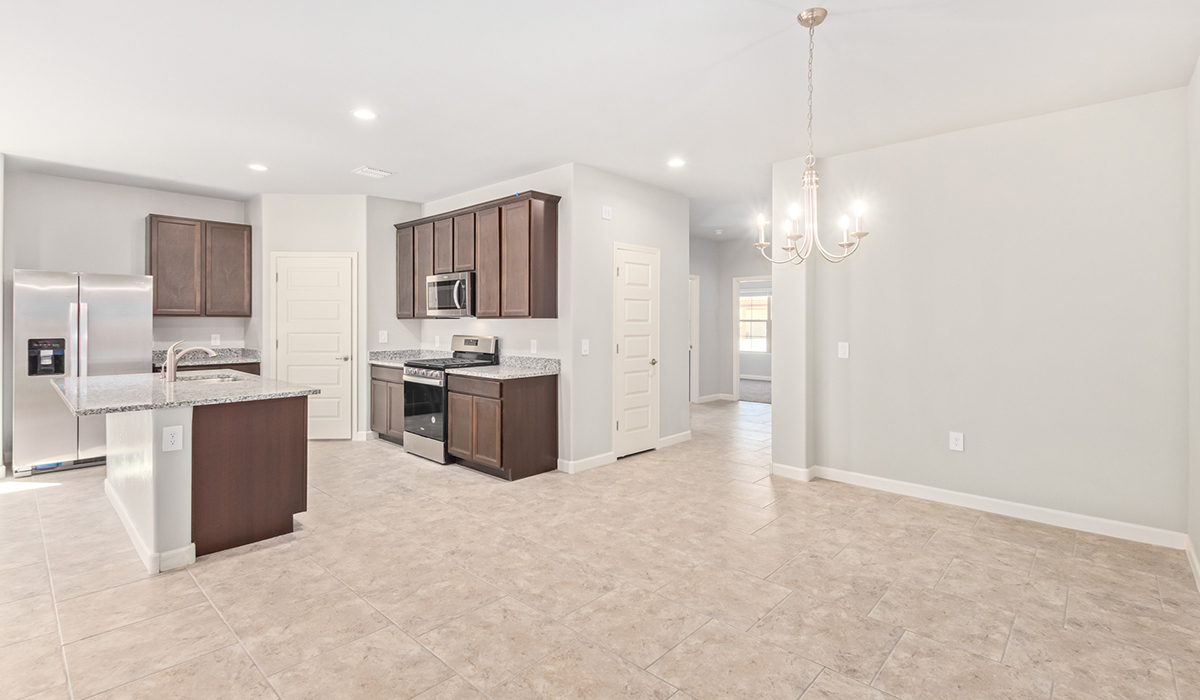 The Lakeway, situated within the beautiful Sycamore Vista community in Vail, Arizona, offers a perfect blend of functionality and comfort, ideal for both growing families and those who appreciate spacious living. With its 2,034 square feet of living space, this single-story new home features five bedrooms and three bathrooms, all meticulously designed to maximize space and convenience.  Entering The Lakeway, you’ll immediately notice the bright and airy atmosphere that flows through the open-concept floor plan. The heart of the home is the great room, seamlessly connected to the kitchen and dining area. The kitchen is equipped with quartz countertops, Shaker-style cabinetry, and a large island that serves as a focal point for both meal preparation and casual gatherings.  The primary bedroom is a true retreat, offering a spacious walk-in closet and an en-suite bathroom. The additional bedrooms are thoughtfully spaced to provide ample privacy for family members or guests, and the two secondary bathrooms are finished with modern fixtures and plenty of storage. This home offers a three-car garage option for substantial space of vehicles and storage, accommodating the practical needs of busy households.  Standard features in The Lakeway at Sycamore Vista include energy-efficient elements like a tankless water heater, spray foam insulation, and LED lighting throughout. The home also comes with a Home is Connected® Smart Home package, which includes a smart thermostat, video doorbell, keyless entry, and more, ensuring modern conveniences are at your fingertips. The front yard is beautifully landscaped and includes an auto drip irrigation system, enhancing the curb appeal of this stunning home.  Nestled within Sycamore Vista, The Lakeway combines the tranquility of a rural setting with proximity to excellent schools, shopping, dining, and outdoor recreation, making it an exceptional place to call home.  *Images shown are for reference only. They depict the model home and may not represent the actual home.