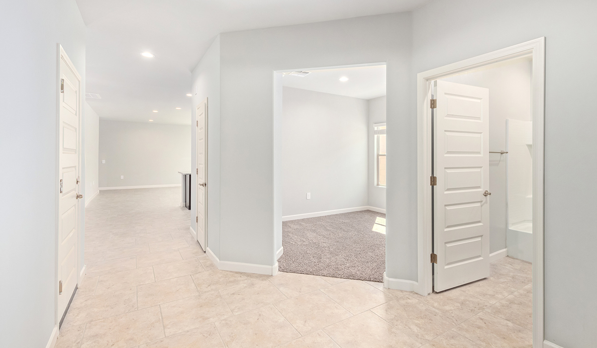 The Lakeway, situated within the beautiful Sycamore Vista community in Vail, Arizona, offers a perfect blend of functionality and comfort, ideal for both growing families and those who appreciate spacious living. With its 2,034 square feet of living space, this single-story new home features five bedrooms and three bathrooms, all meticulously designed to maximize space and convenience.  Entering The Lakeway, you’ll immediately notice the bright and airy atmosphere that flows through the open-concept floor plan. The heart of the home is the great room, seamlessly connected to the kitchen and dining area. The kitchen is equipped with quartz countertops, Shaker-style cabinetry, and a large island that serves as a focal point for both meal preparation and casual gatherings.  The primary bedroom is a true retreat, offering a spacious walk-in closet and an en-suite bathroom. The additional bedrooms are thoughtfully spaced to provide ample privacy for family members or guests, and the two secondary bathrooms are finished with modern fixtures and plenty of storage. This home offers a three-car garage option for substantial space of vehicles and storage, accommodating the practical needs of busy households.  Standard features in The Lakeway at Sycamore Vista include energy-efficient elements like a tankless water heater, spray foam insulation, and LED lighting throughout. The home also comes with a Home is Connected® Smart Home package, which includes a smart thermostat, video doorbell, keyless entry, and more, ensuring modern conveniences are at your fingertips. The front yard is beautifully landscaped and includes an auto drip irrigation system, enhancing the curb appeal of this stunning home.  Nestled within Sycamore Vista, The Lakeway combines the tranquility of a rural setting with proximity to excellent schools, shopping, dining, and outdoor recreation, making it an exceptional place to call home.  *Images shown are for reference only. They depict the model home and may not represent the actual home.