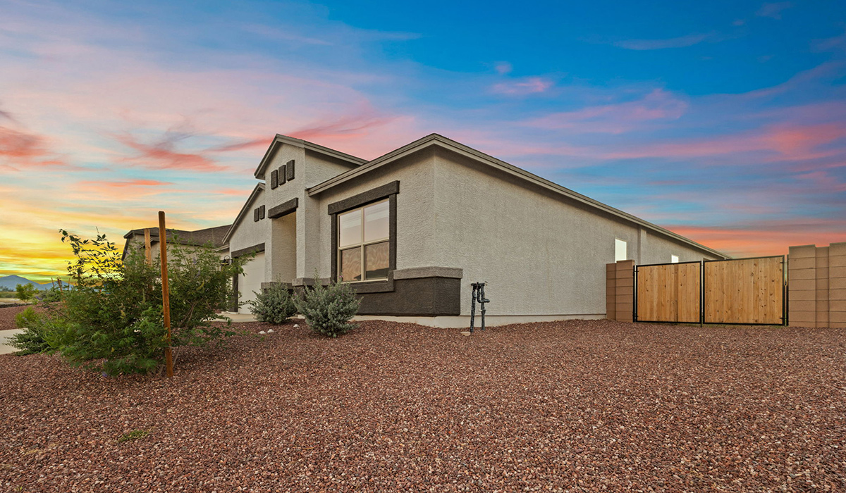 The Lakeway, situated within the beautiful Sycamore Vista community in Vail, Arizona, offers a perfect blend of functionality and comfort, ideal for both growing families and those who appreciate spacious living. With its 2,034 square feet of living space, this single-story new home features five bedrooms and three bathrooms, all meticulously designed to maximize space and convenience.  Entering The Lakeway, you’ll immediately notice the bright and airy atmosphere that flows through the open-concept floor plan. The heart of the home is the great room, seamlessly connected to the kitchen and dining area. The kitchen is equipped with quartz countertops, Shaker-style cabinetry, and a large island that serves as a focal point for both meal preparation and casual gatherings.  The primary bedroom is a true retreat, offering a spacious walk-in closet and an en-suite bathroom. The additional bedrooms are thoughtfully spaced to provide ample privacy for family members or guests, and the two secondary bathrooms are finished with modern fixtures and plenty of storage. This home offers a 2-3 car garage option for substantial space of vehicles and storage, accommodating the practical needs of busy households.  Standard features in The Lakeway at Sycamore Vista include energy-efficient elements like a tankless water heater, spray foam insulation, and LED lighting throughout. The home also comes with a Home is Connected® Smart Home package, which includes a smart thermostat, video doorbell, keyless entry, and more, ensuring modern conveniences are at your fingertips. The front yard is beautifully landscaped and includes an auto drip irrigation system, enhancing the curb appeal of this stunning home.  Nestled within Sycamore Vista, The Lakeway combines the tranquility of a rural setting with proximity to excellent schools, shopping, dining, and outdoor recreation, making it an exceptional place to call home.