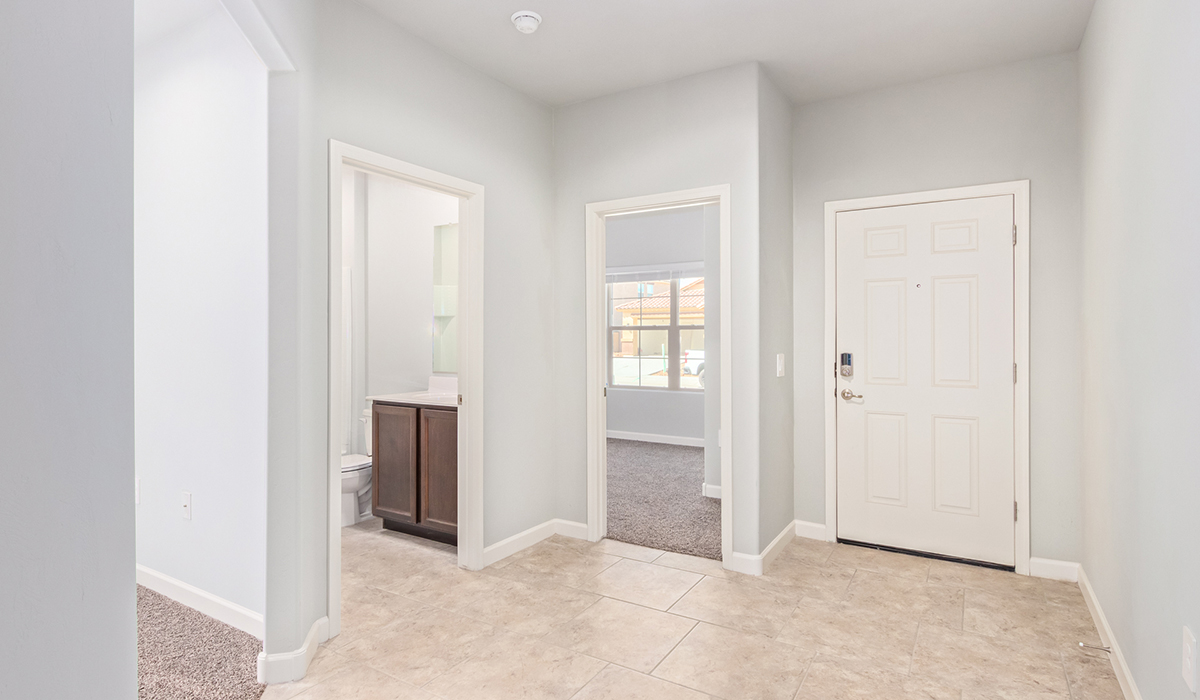 The Lakeway, situated within the beautiful Sycamore Vista community in Vail, Arizona, offers a perfect blend of functionality and comfort, ideal for both growing families and those who appreciate spacious living. With its 2,034 square feet of living space, this single-story new home features five bedrooms and three bathrooms, all meticulously designed to maximize space and convenience.  Entering The Lakeway, you’ll immediately notice the bright and airy atmosphere that flows through the open-concept floor plan. The heart of the home is the great room, seamlessly connected to the kitchen and dining area. The kitchen is equipped with quartz countertops, Shaker-style cabinetry, and a large island that serves as a focal point for both meal preparation and casual gatherings.  The primary bedroom is a true retreat, offering a spacious walk-in closet and an en-suite bathroom. The additional bedrooms are thoughtfully spaced to provide ample privacy for family members or guests, and the two secondary bathrooms are finished with modern fixtures and plenty of storage. This home offers a 2-3 car garage option for substantial space of vehicles and storage, accommodating the practical needs of busy households.  Standard features in The Lakeway at Sycamore Vista include energy-efficient elements like a tankless water heater, spray foam insulation, and LED lighting throughout. The home also comes with a Home is Connected® Smart Home package, which includes a smart thermostat, video doorbell, keyless entry, and more, ensuring modern conveniences are at your fingertips. The front yard is beautifully landscaped and includes an auto drip irrigation system, enhancing the curb appeal of this stunning home.  Nestled within Sycamore Vista, The Lakeway combines the tranquility of a rural setting with proximity to excellent schools, shopping, dining, and outdoor recreation, making it an exceptional place to call home.