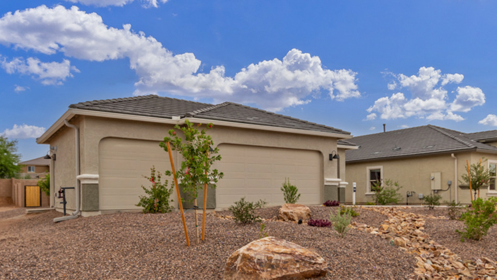 Welcome to The Amber, a thoughtfully designed single-story new home nestled in the Mesquite neighborhood at Saguaro Bloom, a master-planned community in Marana, Arizona. With 1,331 square feet of efficient living space, The Amber is perfect for those seeking a cozy yet functional home environment.  Enter into a welcoming entryway that immediately introduces you to the home’s smart layout. The open design maximizes every square foot, with the heart of the home being the expansive great room, which flows seamlessly into the dining area and kitchen. The kitchen is well-equipped with a central island, quartz countertops, and Shaker-style cabinets, offering a clean and modern aesthetic. A dedicated walk-in pantry adds extra storage, ensuring that all your culinary essentials are within reach.  The Amber offers three comfortable bedrooms. The primary suite is situated at the rear of the home, providing a sense of privacy. It includes a walk-in closet and an en-suite bathroom. The two additional bedrooms are thoughtfully placed near the front of the home, sharing access to a full bathroom, making this layout perfect for families, guests, or a home office.  Practicality meets comfort in this home, with a utility room conveniently located near the kitchen and garage, providing easy access to the laundry area and additional storage. The Amber also includes a covered patio that extends the living space outdoors, ideal for enjoying Arizona’s beautiful weather.  The Amber is not just a home; it’s a lifestyle. Located in the vibrant Saguaro Bloom community, residents enjoy access to a wide range of amenities, from swimming pools and parks to miles of scenic walking trails. Whether you’re a first-time homebuyer or looking to downsize, The Amber offers a perfect blend of comfort, style, and convenience in one of Marana’s most desirable neighborhoods.