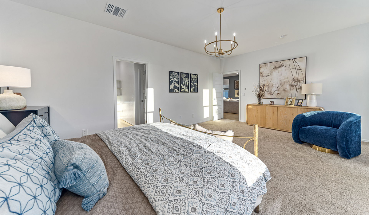 Welcome to the Kingston floor plan at Saguaro Bloom, Marana, Arizona, a perfect blend of comfort, modern living, and energy efficiency. This thoughtfully crafted one-story home spans 2,051 square feet and offers four bedrooms and two bathrooms, ideal for families of all sizes.  The open-concept design features a spacious great room that effortlessly connects with the kitchen and dining area, creating an inviting central hub for everyday living and entertaining. The kitchen is equipped with contemporary appliances and a pantry.  The primary bedroom, located at the rear of the home, provides a peaceful retreat with a private ensuite bathroom and a walk-in closet. The additional three bedrooms are positioned at the front of the house, offering versatility for use as guest rooms, a home office, or children’s bedrooms. Step outside to the covered patio, a perfect spot to enjoy the beautiful Arizona weather.  Built with energy efficiency as a priority, the Kingston includes smart home technology, which not only simplifies daily living but also helps reduce utility costs. A two-car garage provides ample parking and additional storage space, enhancing the home’s functionality.  Residents of Saguaro Bloom enjoy access to a range of community amenities, including parks, walking trails, and recreational facilities, making this home an ideal choice for those seeking a balanced lifestyle in a scenic setting.  *Images shown are for reference only. They depict The Kingston sales model home and may not represent the actual home.