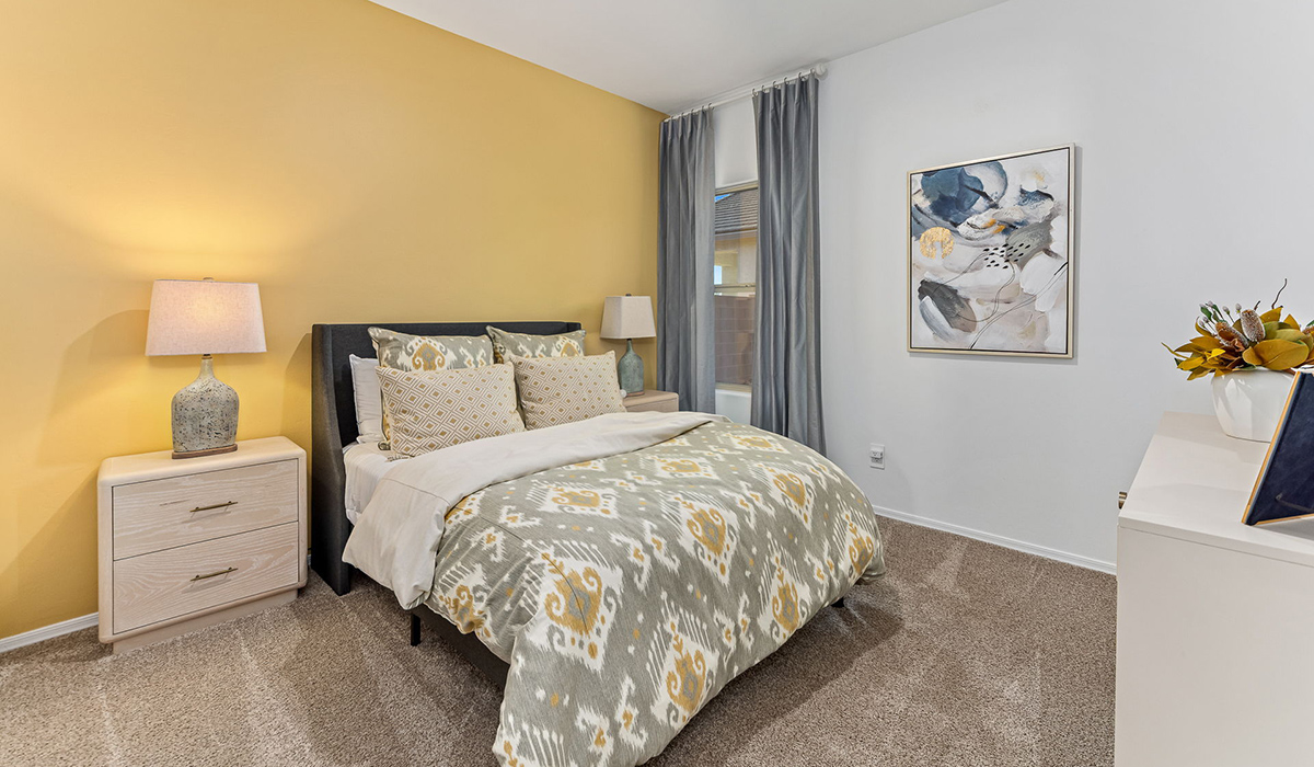 Welcome to the Kingston floor plan at Saguaro Bloom, Marana, Arizona, a perfect blend of comfort, modern living, and energy efficiency. This thoughtfully crafted one-story home spans 2,051 square feet and offers four bedrooms and two bathrooms, ideal for families of all sizes.  The open-concept design features a spacious great room that effortlessly connects with the kitchen and dining area, creating an inviting central hub for everyday living and entertaining. The kitchen is equipped with contemporary appliances and a pantry.  The primary bedroom, located at the rear of the home, provides a peaceful retreat with a private ensuite bathroom and a walk-in closet. The additional three bedrooms are positioned at the front of the house, offering versatility for use as guest rooms, a home office, or children’s bedrooms. Step outside to the covered patio, a perfect spot to enjoy the beautiful Arizona weather.  Built with energy efficiency as a priority, the Kingston includes smart home technology, which not only simplifies daily living but also helps reduce utility costs. A two-car garage provides ample parking and additional storage space, enhancing the home’s functionality.  Residents of Saguaro Bloom enjoy access to a range of community amenities, including parks, walking trails, and recreational facilities, making this home an ideal choice for those seeking a balanced lifestyle in a scenic setting.  *Images shown are for reference only. They depict The Kingston sales model home and may not represent the actual home.