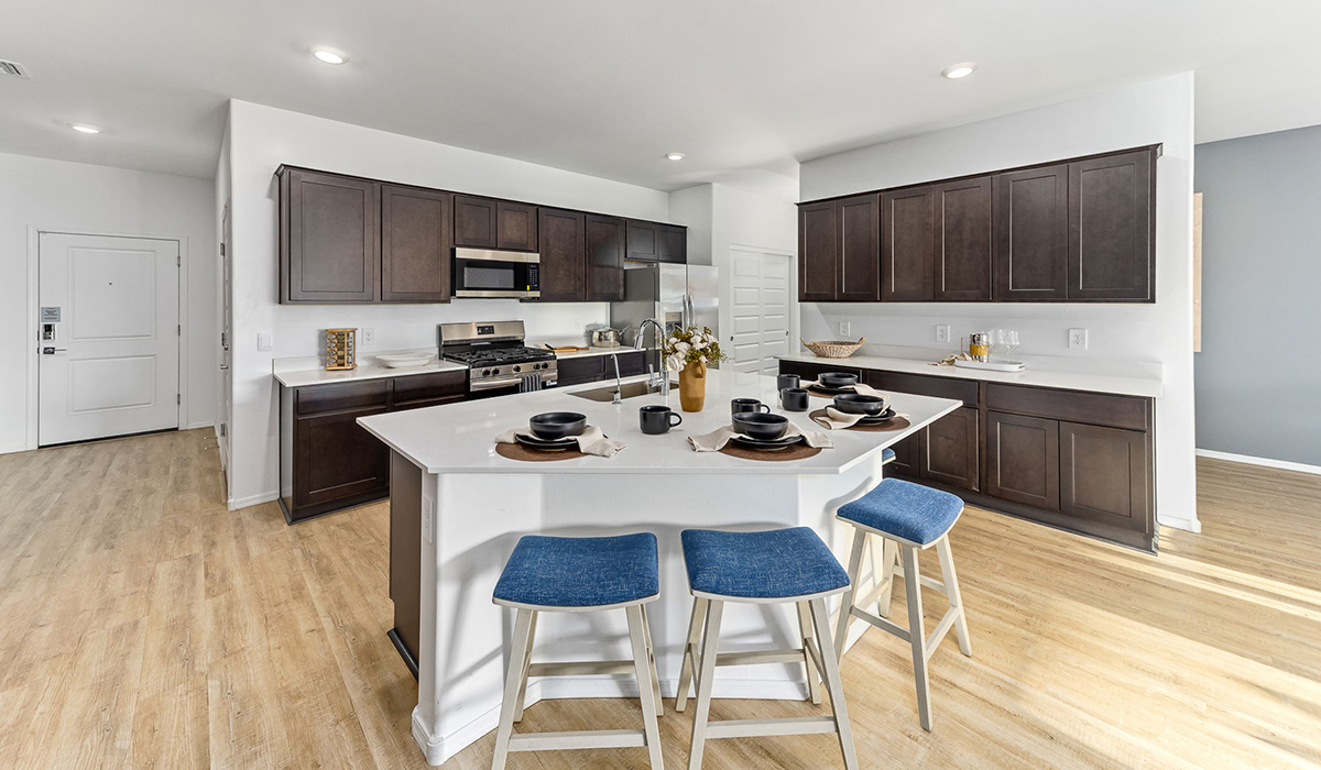Welcome to the Kingston floor plan at Saguaro Bloom, Marana, Arizona, a perfect blend of comfort, modern living, and energy efficiency. This thoughtfully crafted one-story home spans 2,051 square feet and offers four bedrooms and two bathrooms, ideal for families of all sizes.  The open-concept design features a spacious great room that effortlessly connects with the kitchen and dining area, creating an inviting central hub for everyday living and entertaining. The kitchen is equipped with contemporary appliances and a pantry.  The primary bedroom, located at the rear of the home, provides a peaceful retreat with a private ensuite bathroom and a walk-in closet. The additional three bedrooms are positioned at the front of the house, offering versatility for use as guest rooms, a home office, or children’s bedrooms. Step outside to the covered patio, a perfect spot to enjoy the beautiful Arizona weather.  Built with energy efficiency as a priority, the Kingston includes smart home technology, which not only simplifies daily living but also helps reduce utility costs. A two-car garage provides ample parking and additional storage space, enhancing the home’s functionality.  Residents of Saguaro Bloom enjoy access to a range of community amenities, including parks, walking trails, and recreational facilities, making this home an ideal choice for those seeking a balanced lifestyle in a scenic setting.  *Images shown are for reference only. They depict The Kingston sales model home and may not represent the actual home.