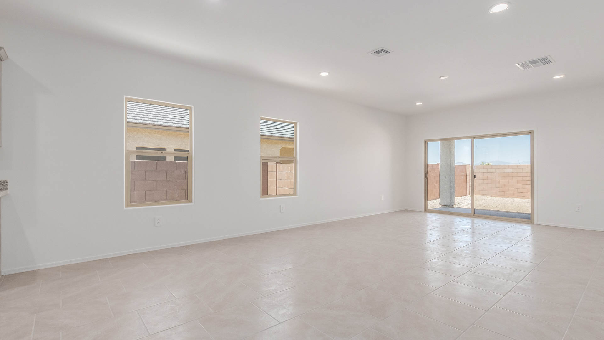 The Parker is a spacious single-story new home situated in the Mesquite neighborhood at Saguaro Bloom, offering 1,909 square feet of well-planned living space that perfectly suits a variety of lifestyles. This home features five bedrooms and three full bathrooms, making it an ideal choice for those needing room to grow.  As you step through the front door, you're greeted by a welcoming foyer that leads you into the heart of the home. The open layout emphasizes a seamless flow between the living, dining, and kitchen areas, ensuring that every part of the home feels connected. The kitchen, equipped with a central island, granite countertops, and your choice of white or gray Shaker-style cabinets, is designed for both functionality and style. A walk-in pantry provides additional storage, making it easy to keep everything organized.  The Parker's five bedrooms are thoughtfully arranged to provide both privacy and convenience. The primary suite is tucked away at the rear of the home, offering a private retreat with a walk-in closet and an en-suite bathroom complete with dual vanities. The additional bedrooms are strategically placed near the front and center of the home, each with access to a full bathroom, ensuring comfort for all family members or guests.  The large great room serves as the central gathering space, perfect for family activities or entertaining guests. Adjacent to the great room is a covered patio, extending your living space outdoors and offering a perfect spot to enjoy the serene surroundings of Saguaro Bloom.  Practical features like a dedicated utility room and a spacious two-car garage enhance the functionality of this home, while large windows ensure that natural light fills the space, creating a bright and inviting atmosphere.  Located within the vibrant Saguaro Bloom community, residents of The Parker can take advantage of a wide array of amenities, from resort-style pools to extensive walking trails. This home offers a unique opportunity to enjoy both comfort and community in one of Marana’s most sought-after neighborhoods.