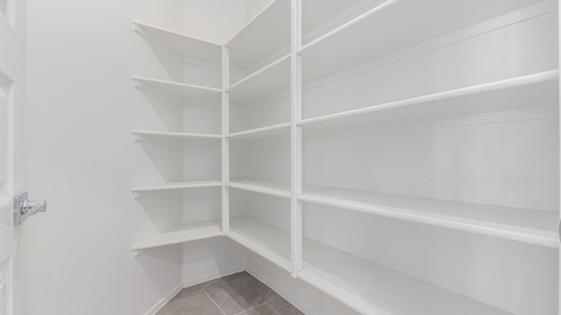 The Parker is a spacious single-story new home situated in the Mesquite neighborhood at Saguaro Bloom, offering 1,909 square feet of well-planned living space that perfectly suits a variety of lifestyles. This home features five bedrooms and three full bathrooms, making it an ideal choice for those needing room to grow.  As you step through the front door, you're greeted by a welcoming foyer that leads you into the heart of the home. The open layout emphasizes a seamless flow between the living, dining, and kitchen areas, ensuring that every part of the home feels connected. The kitchen, equipped with a central island, granite countertops, and your choice of white or gray Shaker-style cabinets, is designed for both functionality and style. A walk-in pantry provides additional storage, making it easy to keep everything organized.  The Parker's five bedrooms are thoughtfully arranged to provide both privacy and convenience. The primary suite is tucked away at the rear of the home, offering a private retreat with a walk-in closet and an en-suite bathroom complete with dual vanities. The additional bedrooms are strategically placed near the front and center of the home, each with access to a full bathroom, ensuring comfort for all family members or guests.  The large great room serves as the central gathering space, perfect for family activities or entertaining guests. Adjacent to the great room is a covered patio, extending your living space outdoors and offering a perfect spot to enjoy the serene surroundings of Saguaro Bloom.  Practical features like a dedicated utility room and a spacious two-car garage enhance the functionality of this home, while large windows ensure that natural light fills the space, creating a bright and inviting atmosphere.  Located within the vibrant Saguaro Bloom community, residents of The Parker can take advantage of a wide array of amenities, from resort-style pools to extensive walking trails. This home offers a unique opportunity to enjoy both comfort and community in one of Marana’s most sought-after neighborhoods.