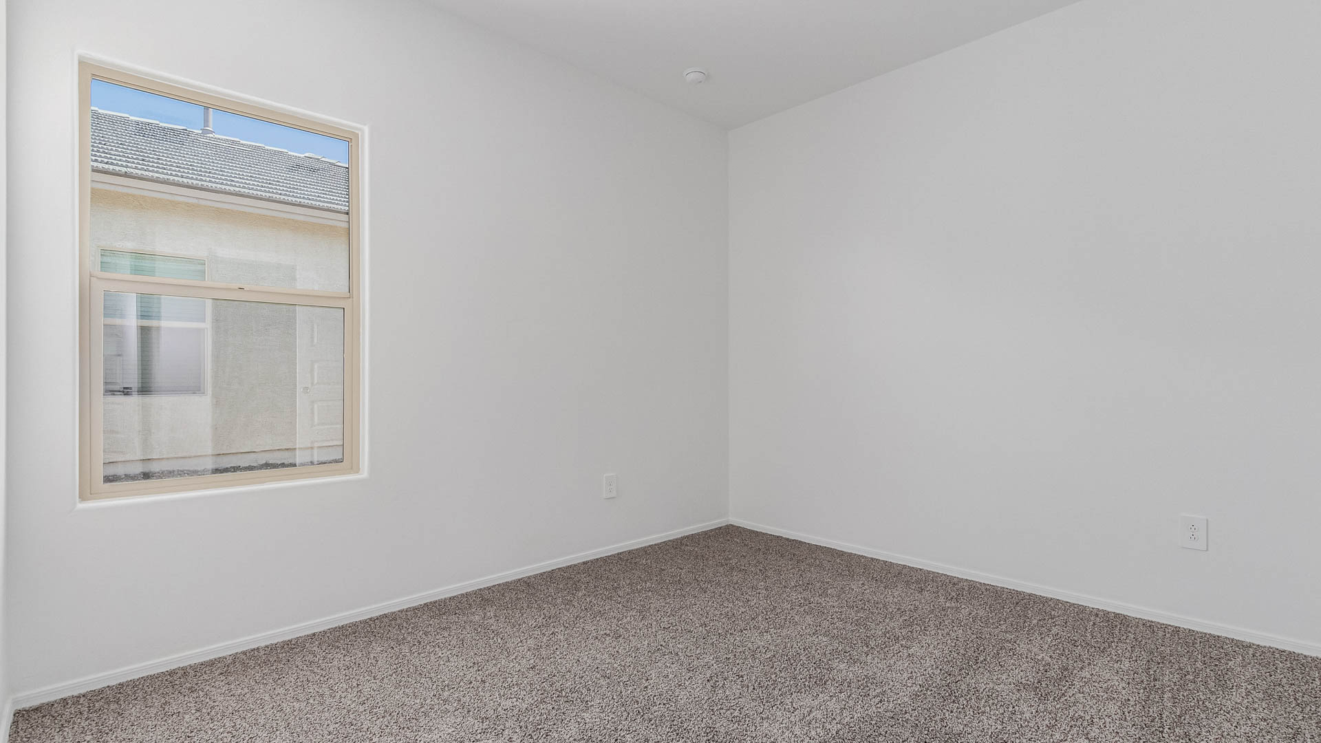 The Parker is a spacious single-story new home situated in the Mesquite neighborhood at Saguaro Bloom, offering 1,909 square feet of well-planned living space that perfectly suits a variety of lifestyles. This home features five bedrooms and three full bathrooms, making it an ideal choice for those needing room to grow.  As you step through the front door, you're greeted by a welcoming foyer that leads you into the heart of the home. The open layout emphasizes a seamless flow between the living, dining, and kitchen areas, ensuring that every part of the home feels connected. The kitchen, equipped with a central island, granite countertops, and your choice of white or gray Shaker-style cabinets, is designed for both functionality and style. A walk-in pantry provides additional storage, making it easy to keep everything organized.  The Parker's five bedrooms are thoughtfully arranged to provide both privacy and convenience. The primary suite is tucked away at the rear of the home, offering a private retreat with a walk-in closet and an en-suite bathroom complete with dual vanities. The additional bedrooms are strategically placed near the front and center of the home, each with access to a full bathroom, ensuring comfort for all family members or guests.  The large great room serves as the central gathering space, perfect for family activities or entertaining guests. Adjacent to the great room is a covered patio, extending your living space outdoors and offering a perfect spot to enjoy the serene surroundings of Saguaro Bloom.  Practical features like a dedicated utility room and a spacious two-car garage enhance the functionality of this home, while large windows ensure that natural light fills the space, creating a bright and inviting atmosphere.  Located within the vibrant Saguaro Bloom community, residents of The Parker can take advantage of a wide array of amenities, from resort-style pools to extensive walking trails. This home offers a unique opportunity to enjoy both comfort and community in one of Marana’s most sought-after neighborhoods.