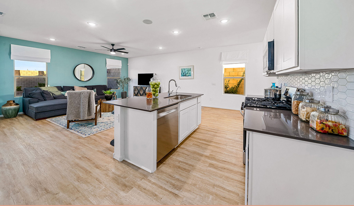 Introducing The Kate, a spacious two-story new home located in the Mesquite neighborhood at Saguaro Bloom, one of Marana's premier communities. This residence, offering 2,264 square feet of living space, is designed to accommodate a variety of lifestyles, with four bedrooms and two and a half bathrooms.  As you enter through the welcoming front porch, you’re immediately drawn into an expansive and open living area. The great room, which flows effortlessly into the dining area and kitchen, serves as the heart of the home, making it perfect for gatherings and everyday living. The kitchen is both functional and stylish, featuring a central island, quartz countertops, and Shaker-style cabinetry. A pantry provides additional storage, keeping your kitchen organized.  Upstairs, The Kate continues to impress with a layout that emphasizes comfort and convenience. The primary bedroom is a peaceful getaway, complete with a walk-in closet and ensuite bathroom. The additional three bedrooms are generously sized and share access to a full bathroom. A dedicated loft provides a flexible space that can be used as a play area, media room, or home office.  The home also includes a powder room on the main level, perfect for guests, and a large utility room upstairs, adding practicality to the daily routine. The covered patio extends your living space outdoors, ideal for enjoying the beautiful Arizona weather.  Built with modern living in mind, The Kate has energy-efficient features, ensuring comfort and sustainability for years to come. Large windows throughout the home allow natural light to brighten every corner, creating a warm and inviting atmosphere.  Situated within the vibrant Saguaro Bloom community, residents have access to many amenities, including swimming pools, walking trails, and parks.   *Images shown are for reference only. They depict the sales model home and may not represent the actual home.