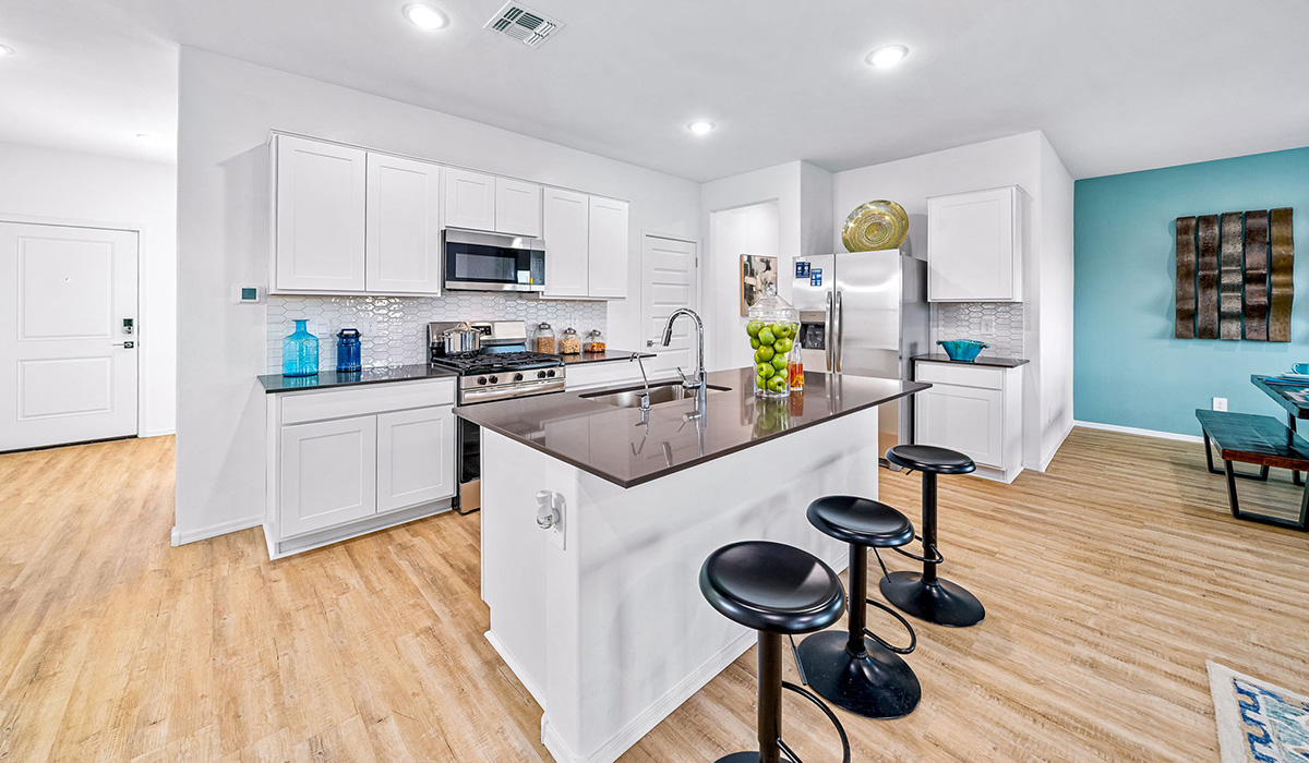 Introducing The Kate, a spacious two-story new home located in the Mesquite neighborhood at Saguaro Bloom, one of Marana's premier communities. This residence, offering 2,264 square feet of living space, is designed to accommodate a variety of lifestyles, with four bedrooms and two and a half bathrooms.  As you enter through the welcoming front porch, you’re immediately drawn into an expansive and open living area. The great room, which flows effortlessly into the dining area and kitchen, serves as the heart of the home, making it perfect for gatherings and everyday living. The kitchen is both functional and stylish, featuring a central island, quartz countertops, and Shaker-style cabinetry. A pantry provides additional storage, keeping your kitchen organized.  Upstairs, The Kate continues to impress with a layout that emphasizes comfort and convenience. The primary bedroom is a peaceful getaway, complete with a walk-in closet and ensuite bathroom. The additional three bedrooms are generously sized and share access to a full bathroom. A dedicated loft provides a flexible space that can be used as a play area, media room, or home office.  The home also includes a powder room on the main level, perfect for guests, and a large utility room upstairs, adding practicality to the daily routine. The covered patio extends your living space outdoors, ideal for enjoying the beautiful Arizona weather.  Built with modern living in mind, The Kate has energy-efficient features, ensuring comfort and sustainability for years to come. Large windows throughout the home allow natural light to brighten every corner, creating a warm and inviting atmosphere.  Situated within the vibrant Saguaro Bloom community, residents have access to many amenities, including swimming pools, walking trails, and parks.   *Images shown are for reference only. They depict the sales model home and may not represent the actual home.