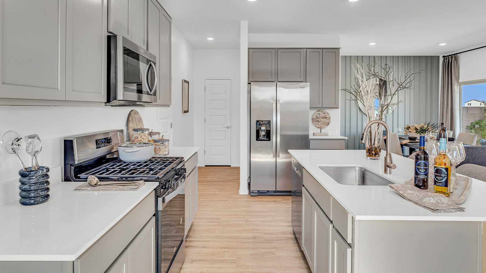 Introducing The Kate, a spacious two-story new home located in the Mesquite neighborhood at Saguaro Bloom, one of Marana's premier communities. This residence, offering 2,264 square feet of living space, is designed to accommodate a variety of lifestyles, with four bedrooms and two and a half bathrooms.  As you enter through the welcoming front porch, you’re immediately drawn into an expansive and open living area. The great room, which flows effortlessly into the dining area and kitchen, serves as the heart of the home, making it perfect for gatherings and everyday living. The kitchen is both functional and stylish, featuring a central island, granite countertops, and Shaker-style cabinetry in your choice of white or gray. A pantry provides additional storage, keeping your kitchen organized and clutter-free.  Upstairs, The Kate continues to impress with a layout that emphasizes comfort and convenience. The primary bedroom is a peaceful getaway, complete with a walk-in closet and a private bathroom featuring dual sinks. The additional three bedrooms are generously sized and share access to a full bathroom. A dedicated game room provides flexible space that can be used as a play area, media room, or home office.  The home also includes a powder room on the main level, perfect for guests, and a large utility room upstairs, adding practicality to the daily routine. The covered patio extends your living space outdoors, ideal for enjoying the beautiful Arizona weather or entertaining guests.  Built with modern living in mind, The Kate incorporates energy-efficient features and smart home technology, ensuring comfort and sustainability for years to come. Large windows throughout the home allow natural light to brighten every corner, creating a warm and inviting atmosphere.  Situated within the vibrant Saguaro Bloom community, residents of The Kate enjoy access to a wealth of amenities, including swimming pools, walking trails, parks, and more. This home offers the perfect blend of style, comfort, and community, making it a standout choice in the Marana area.  *Images shown are for reference only. They depict the sales model home and may not represent the actual home.