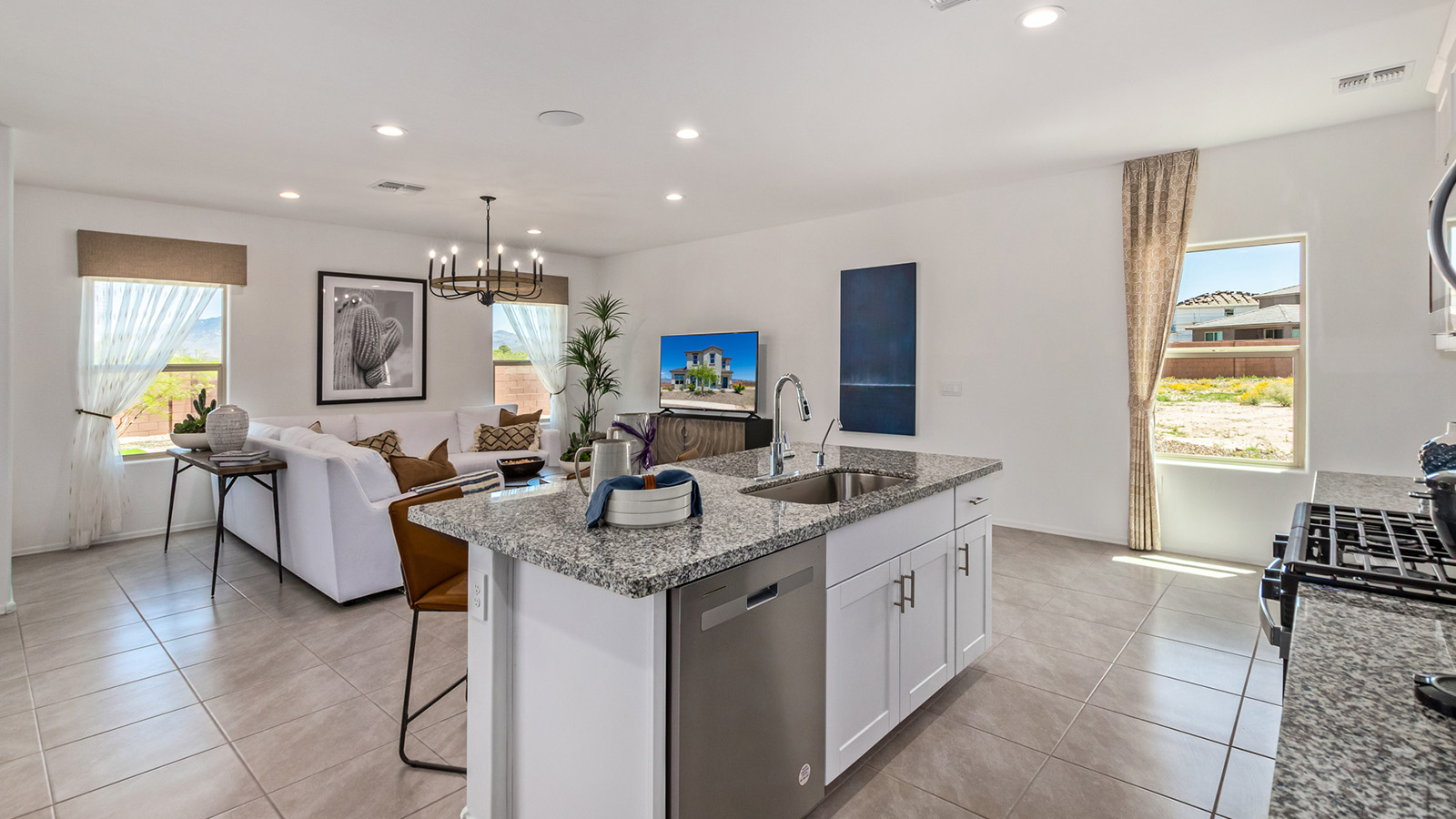 Introducing The Kate, a spacious two-story new home located in the Mesquite neighborhood at Saguaro Bloom, one of Marana's premier communities. This residence, offering 2,264 square feet of living space, is designed to accommodate a variety of lifestyles, with four bedrooms and two and a half bathrooms.  As you enter through the welcoming front porch, you’re immediately drawn into an expansive and open living area. The great room, which flows effortlessly into the dining area and kitchen, serves as the heart of the home, making it perfect for gatherings and everyday living. The kitchen is both functional and stylish, featuring a central island, quartz countertops, and Shaker-style cabinetry. A pantry provides additional storage, keeping your kitchen organized.  Upstairs, The Kate continues to impress with a layout that emphasizes comfort and convenience. The primary bedroom is a peaceful getaway, complete with a walk-in closet and ensuite bathroom. The additional three bedrooms are generously sized and share access to a full bathroom. A dedicated loft provides a flexible space that can be used as a play area, media room, or home office.  The home also includes a powder room on the main level, perfect for guests, and a large utility room upstairs, adding practicality to the daily routine. The covered patio extends your living space outdoors, ideal for enjoying the beautiful Arizona weather.  Built with modern living in mind, The Kate has energy-efficient features, ensuring comfort and sustainability for years to come. Large windows throughout the home allow natural light to brighten every corner, creating a warm and inviting atmosphere.  Situated within the vibrant Saguaro Bloom community, residents have access to many amenities, including swimming pools, walking trails, and parks.   *Images shown are for reference only. They depict the sales model home and may not represent the actual home.