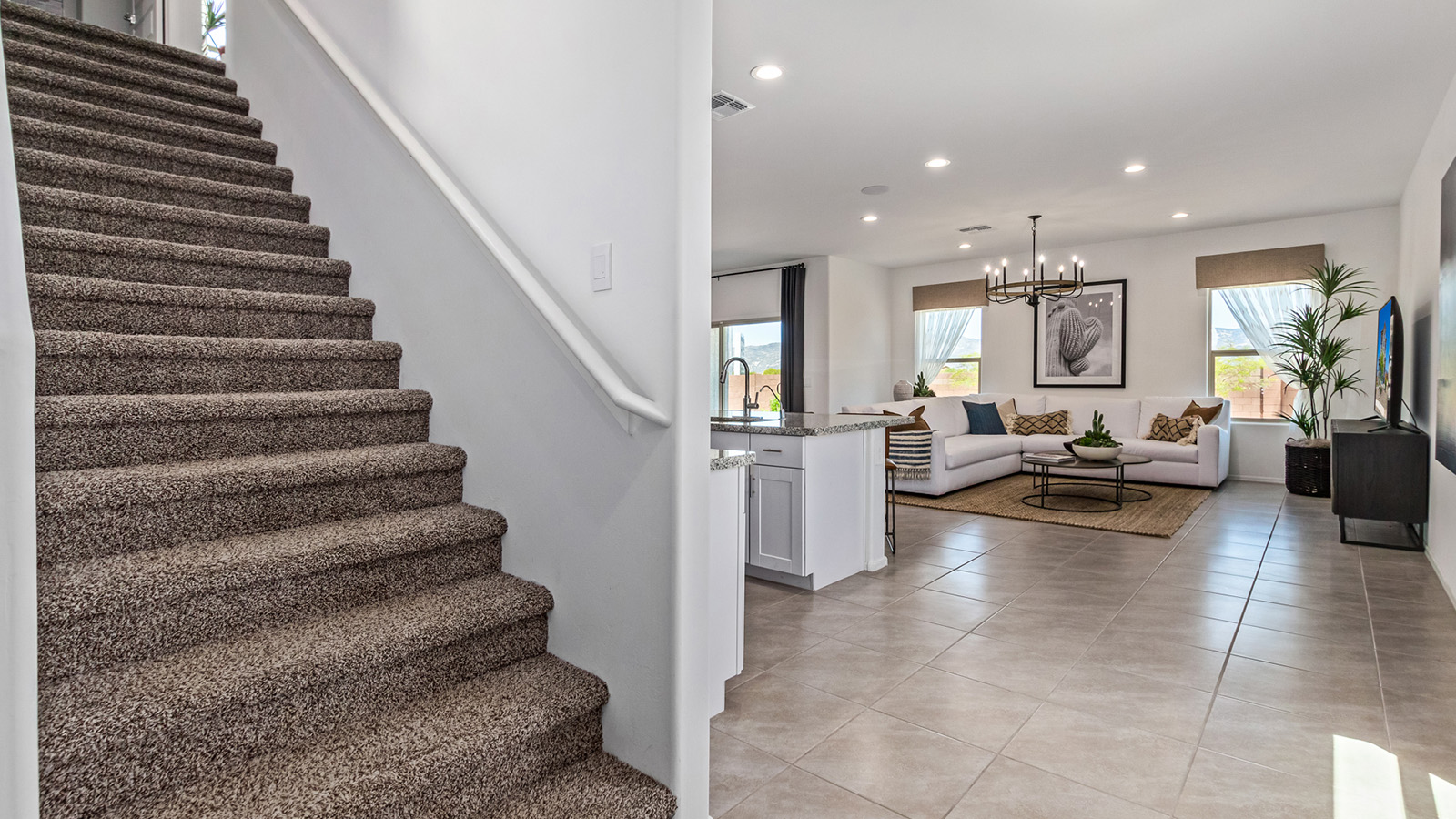 Introducing The Kate, a spacious two-story new home located in the Mesquite neighborhood at Saguaro Bloom, one of Marana's premier communities. This residence, offering 2,264 square feet of living space, is designed to accommodate a variety of lifestyles, with four bedrooms and two and a half bathrooms.  As you enter through the welcoming front porch, you’re immediately drawn into an expansive and open living area. The great room, which flows effortlessly into the dining area and kitchen, serves as the heart of the home, making it perfect for gatherings and everyday living. The kitchen is both functional and stylish, featuring a central island, quartz countertops, and Shaker-style cabinetry. A pantry provides additional storage, keeping your kitchen organized.  Upstairs, The Kate continues to impress with a layout that emphasizes comfort and convenience. The primary bedroom is a peaceful getaway, complete with a walk-in closet and ensuite bathroom. The additional three bedrooms are generously sized and share access to a full bathroom. A dedicated loft provides a flexible space that can be used as a play area, media room, or home office.  The home also includes a powder room on the main level, perfect for guests, and a large utility room upstairs, adding practicality to the daily routine. The covered patio extends your living space outdoors, ideal for enjoying the beautiful Arizona weather.  Built with modern living in mind, The Kate has energy-efficient features, ensuring comfort and sustainability for years to come. Large windows throughout the home allow natural light to brighten every corner, creating a warm and inviting atmosphere.  Situated within the vibrant Saguaro Bloom community, residents have access to many amenities, including swimming pools, walking trails, and parks.   *Images shown are for reference only. They depict the sales model home and may not represent the actual home.