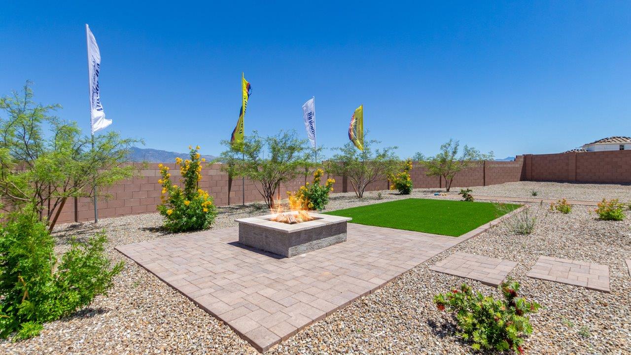 Introducing The Kate, a spacious two-story new home located in the Mesquite neighborhood at Saguaro Bloom, one of Marana's premier communities. This residence, offering 2,264 square feet of living space, is designed to accommodate a variety of lifestyles, with four bedrooms and two and a half bathrooms.  As you enter through the welcoming front porch, you’re immediately drawn into an expansive and open living area. The great room, which flows effortlessly into the dining area and kitchen, serves as the heart of the home, making it perfect for gatherings and everyday living. The kitchen is both functional and stylish, featuring a central island, quartz countertops, and Shaker-style cabinetry. A pantry provides additional storage, keeping your kitchen organized.  Upstairs, The Kate continues to impress with a layout that emphasizes comfort and convenience. The primary bedroom is a peaceful getaway, complete with a walk-in closet and ensuite bathroom. The additional three bedrooms are generously sized and share access to a full bathroom. A dedicated loft provides a flexible space that can be used as a play area, media room, or home office.  The home also includes a powder room on the main level, perfect for guests, and a large utility room upstairs, adding practicality to the daily routine. The covered patio extends your living space outdoors, ideal for enjoying the beautiful Arizona weather.  Built with modern living in mind, The Kate has energy-efficient features, ensuring comfort and sustainability for years to come. Large windows throughout the home allow natural light to brighten every corner, creating a warm and inviting atmosphere.  Situated within the vibrant Saguaro Bloom community, residents have access to many amenities, including swimming pools, walking trails, and parks.   *Images shown are for reference only. They depict the sales model home and may not represent the actual home.