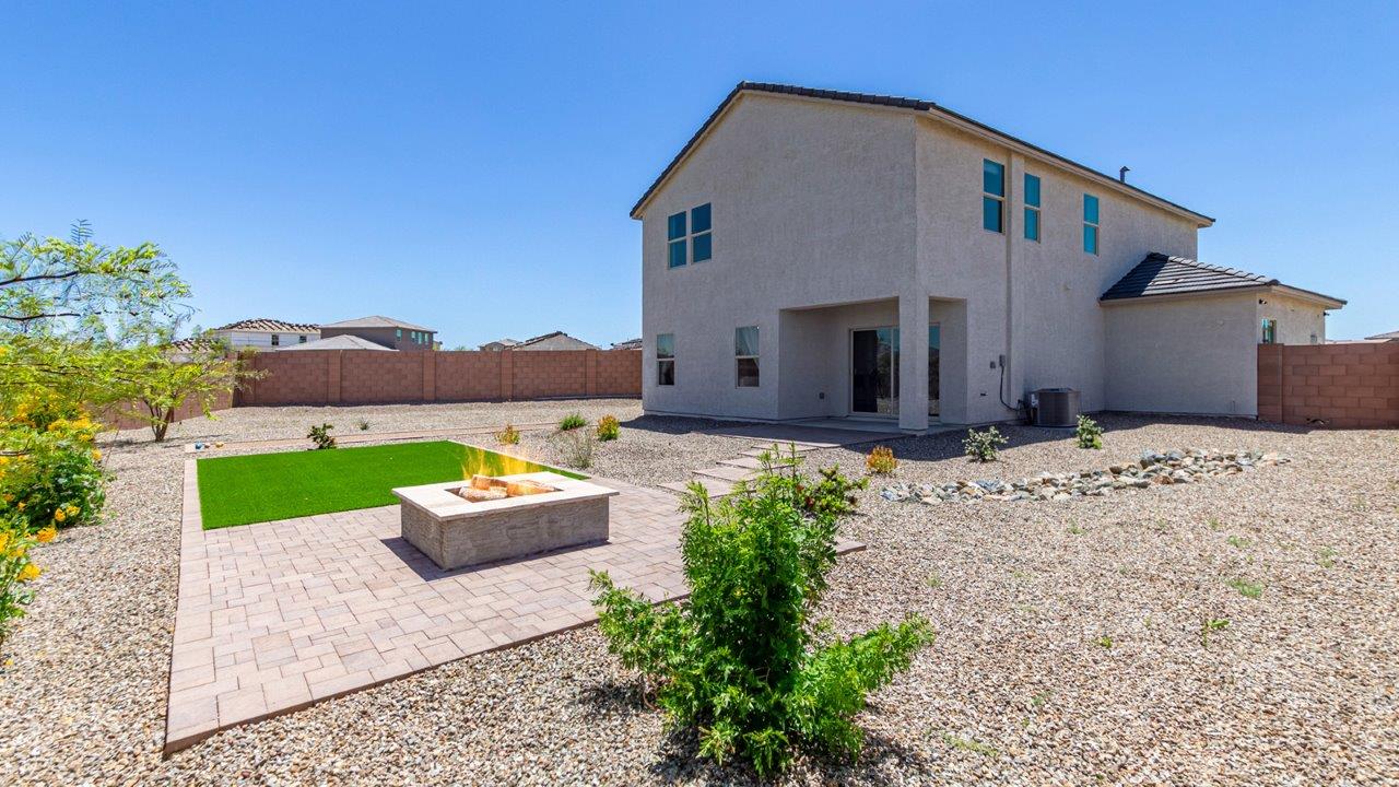 Introducing The Kate, a spacious two-story new home located in the Mesquite neighborhood at Saguaro Bloom, one of Marana's premier communities. This residence, offering 2,264 square feet of living space, is designed to accommodate a variety of lifestyles, with four bedrooms and two and a half bathrooms.  As you enter through the welcoming front porch, you’re immediately drawn into an expansive and open living area. The great room, which flows effortlessly into the dining area and kitchen, serves as the heart of the home, making it perfect for gatherings and everyday living. The kitchen is both functional and stylish, featuring a central island, quartz countertops, and Shaker-style cabinetry. A pantry provides additional storage, keeping your kitchen organized.  Upstairs, The Kate continues to impress with a layout that emphasizes comfort and convenience. The primary bedroom is a peaceful getaway, complete with a walk-in closet and ensuite bathroom. The additional three bedrooms are generously sized and share access to a full bathroom. A dedicated loft provides a flexible space that can be used as a play area, media room, or home office.  The home also includes a powder room on the main level, perfect for guests, and a large utility room upstairs, adding practicality to the daily routine. The covered patio extends your living space outdoors, ideal for enjoying the beautiful Arizona weather.  Built with modern living in mind, The Kate has energy-efficient features, ensuring comfort and sustainability for years to come. Large windows throughout the home allow natural light to brighten every corner, creating a warm and inviting atmosphere.  Situated within the vibrant Saguaro Bloom community, residents have access to many amenities, including swimming pools, walking trails, and parks.   *Images shown are for reference only. They depict the sales model home and may not represent the actual home.